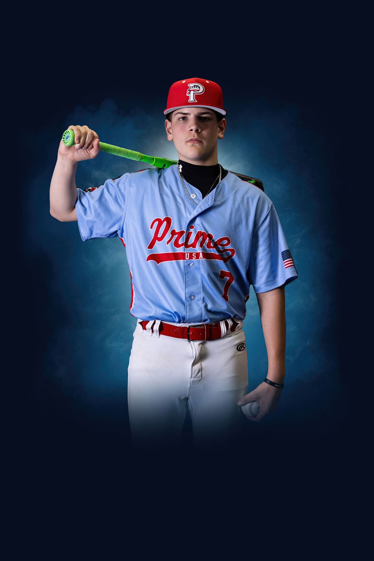 Young baseball player in Prime jersey #7 poses with green bat on blue background.