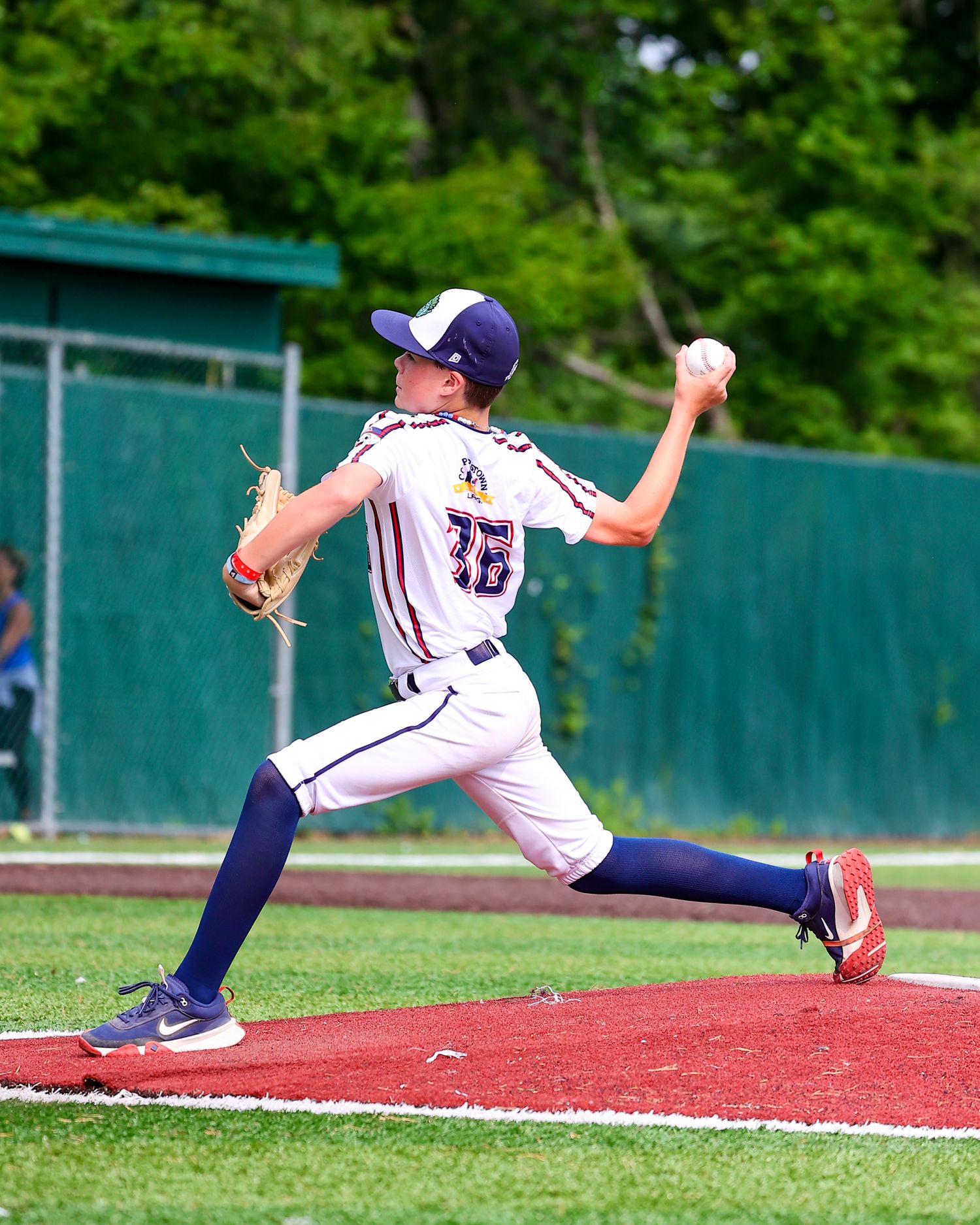 Baseball pitcher shown in sequence of four action shots demonstrating pitching form and follow-through motion on field.