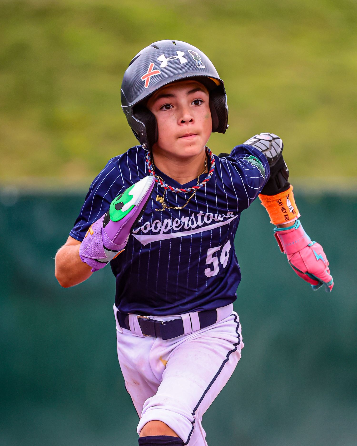 Young baseball player in pinstripe uniform swings bat during game, shown in three action sequence photos.