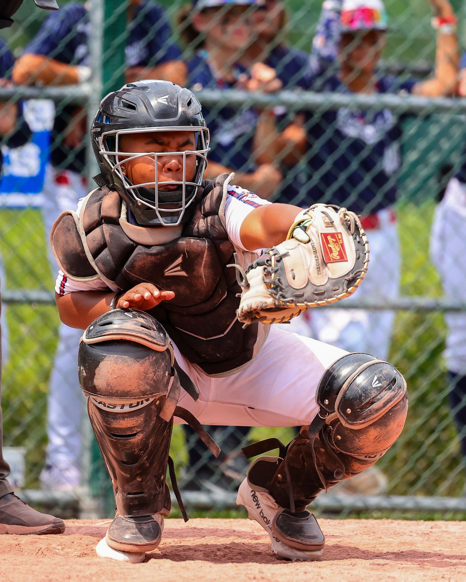 Close-up sequence of baseball catcher's mitts and protective gear positioned at home plate during a game.
