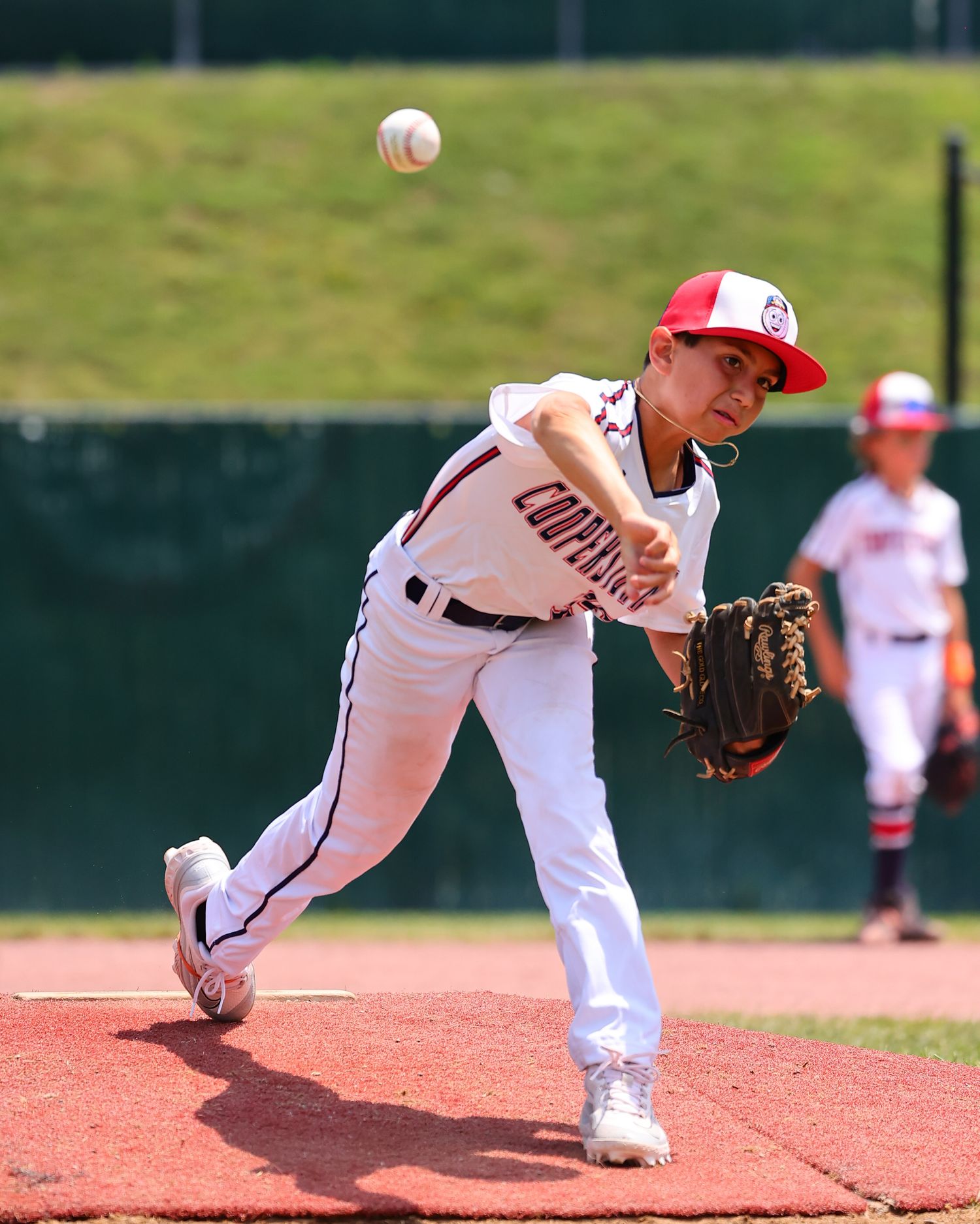 Baseball pitcher in mid-delivery sequence showing progression of throwing motion from wind-up to follow through.
