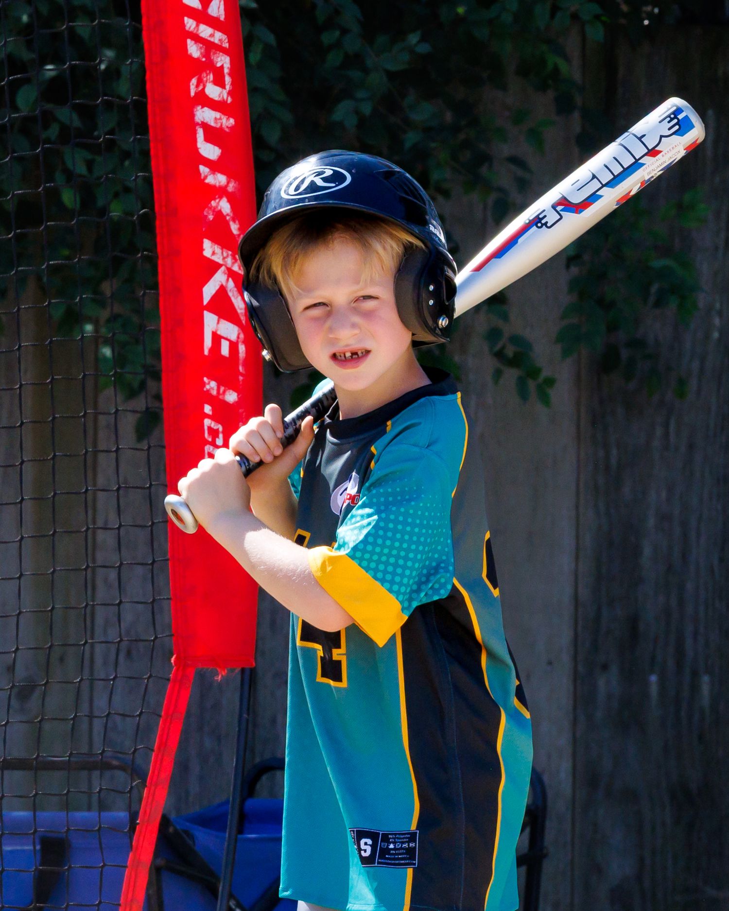 A young baseball player in a teal jersey practices batting stance and swinging techniques in a sequence of photos.