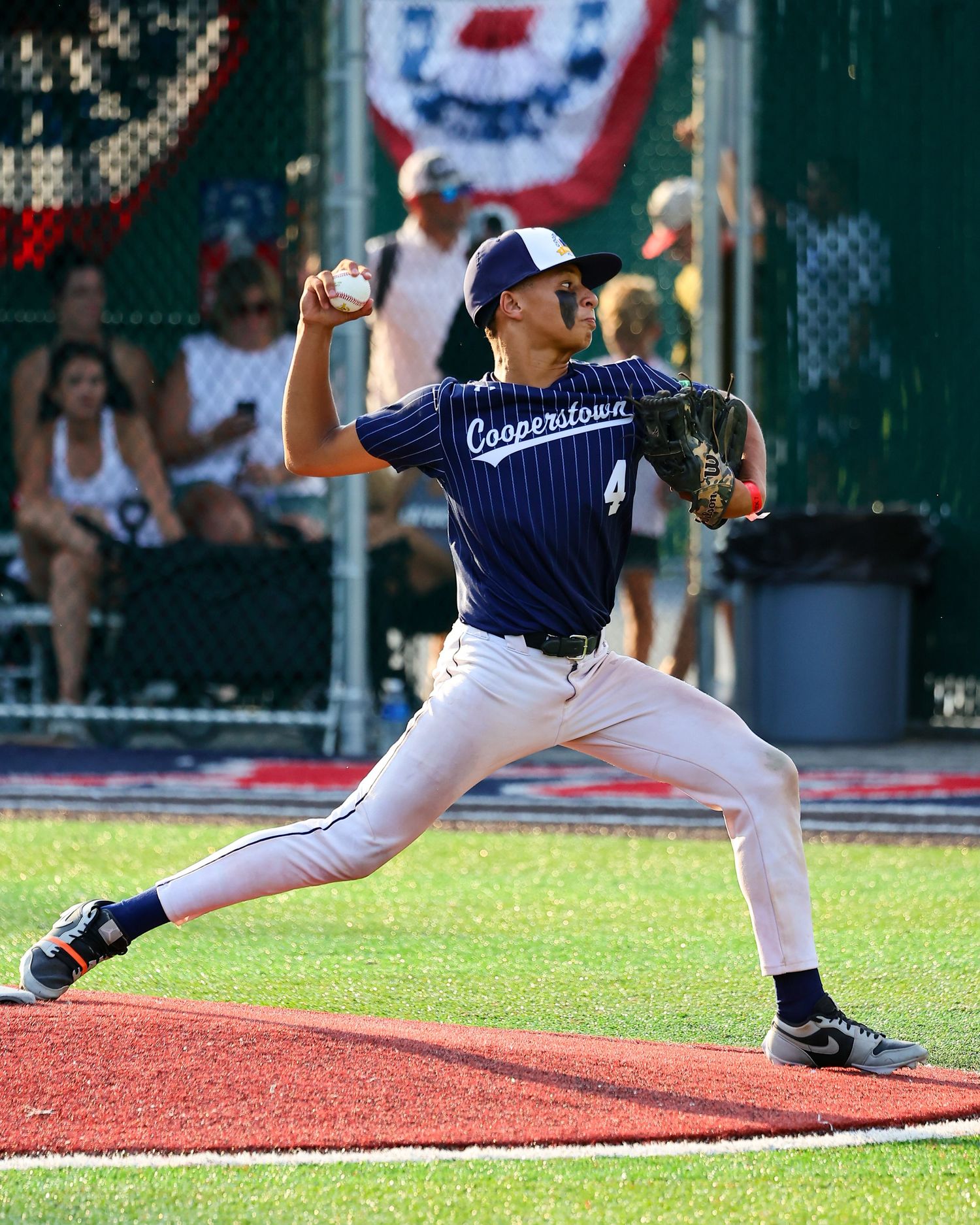Baseball pitcher shown in sequence of four frames demonstrating proper throwing motion mechanics on the field.