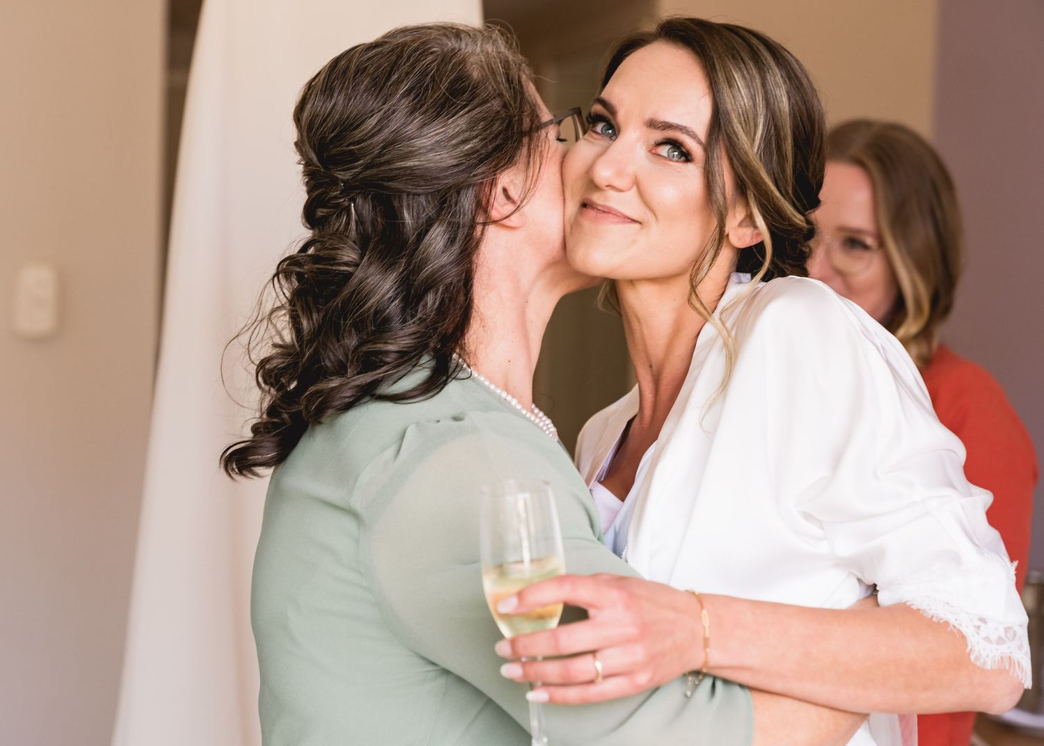 Two people sharing an intimate moment while holding champagne glasses.