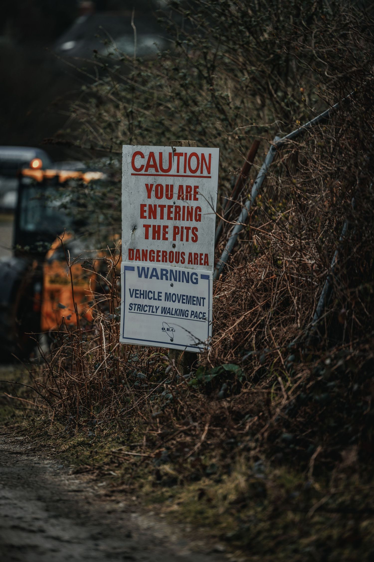 Warning sign for pit area entrance indicating dangerous vehicle movement zone.