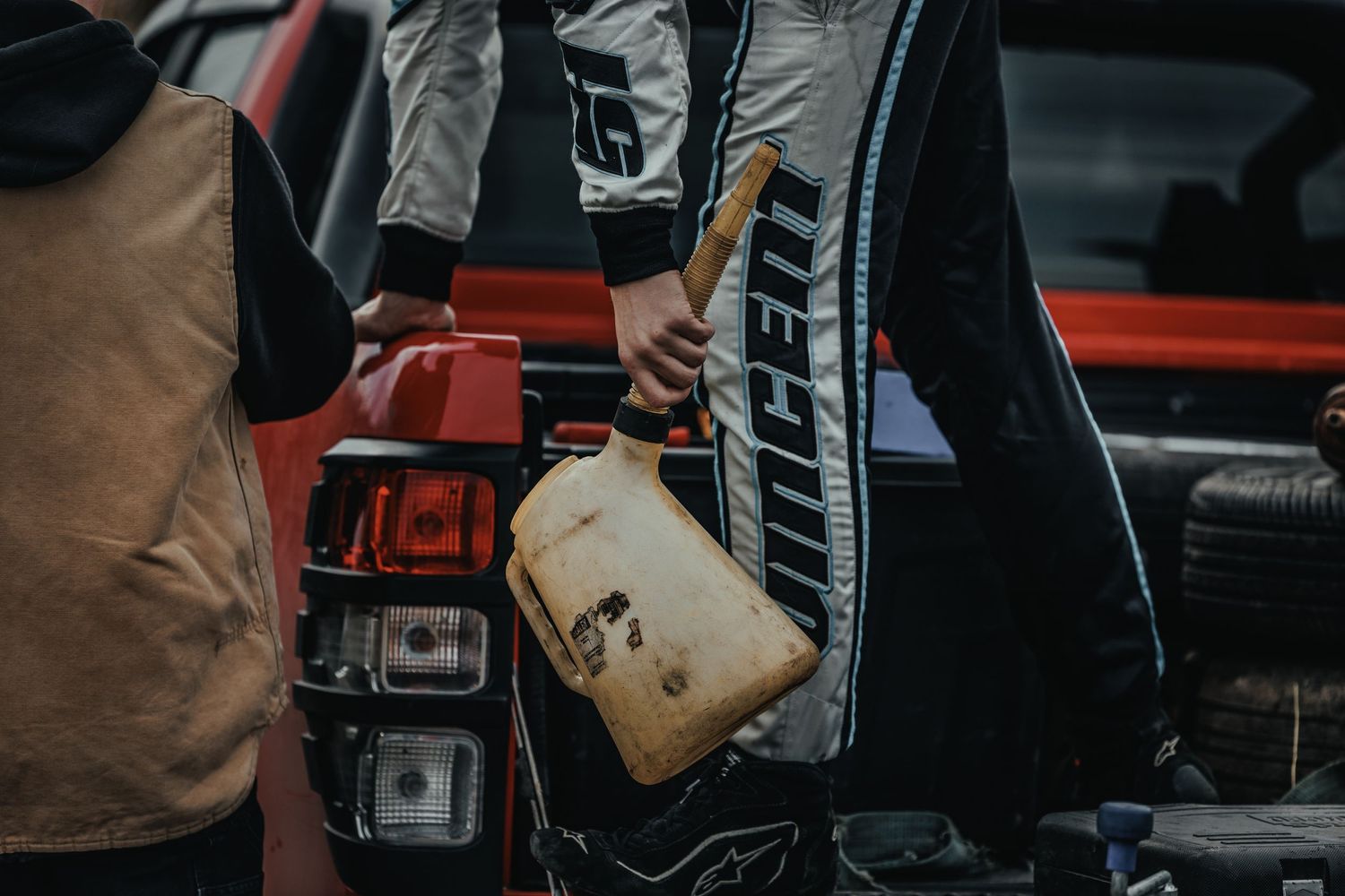 Close-up detail of racing equipment and gear showing worn patches and logos.