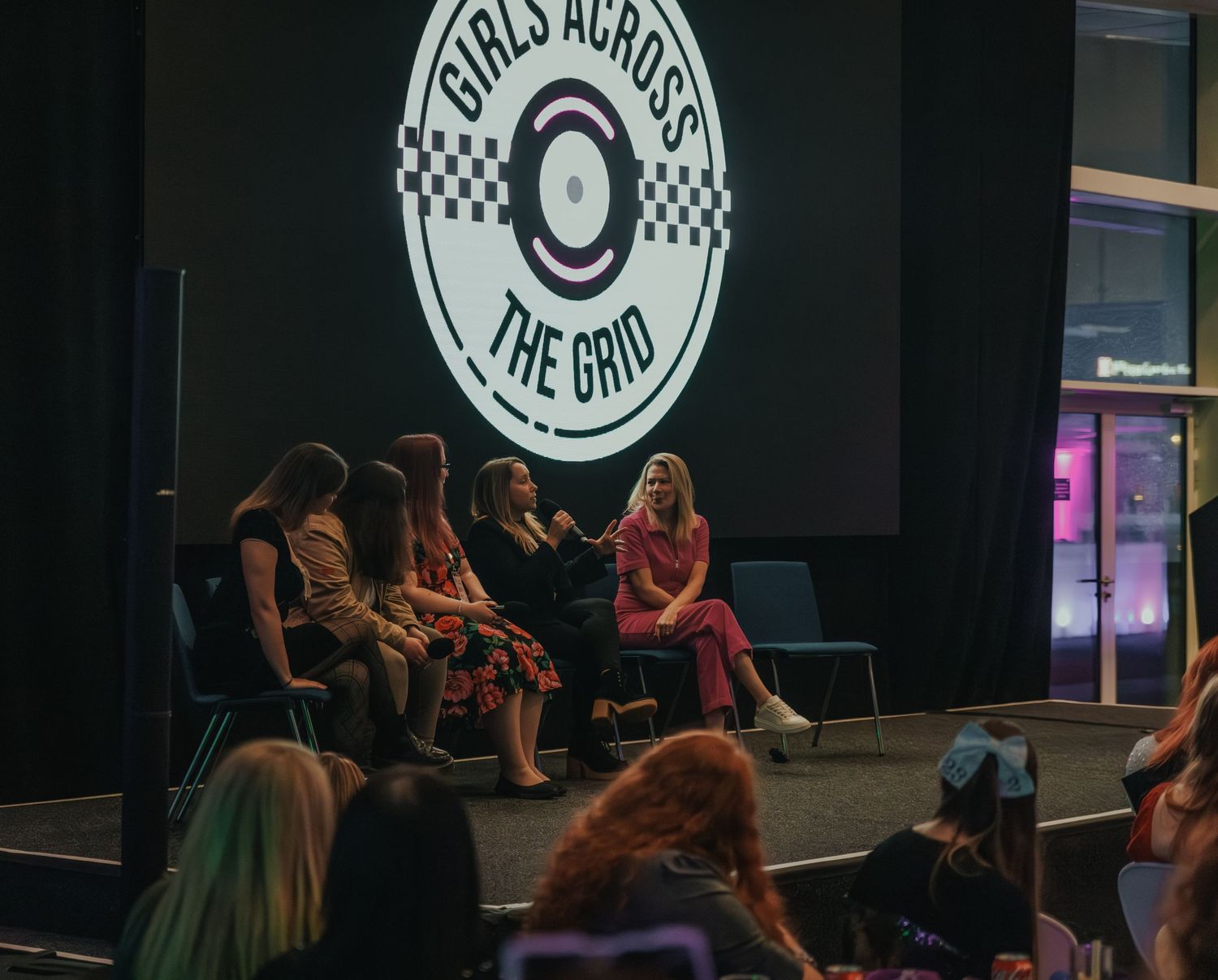 Group discussion panel at Girls Across The Grid event with audience in attendance.