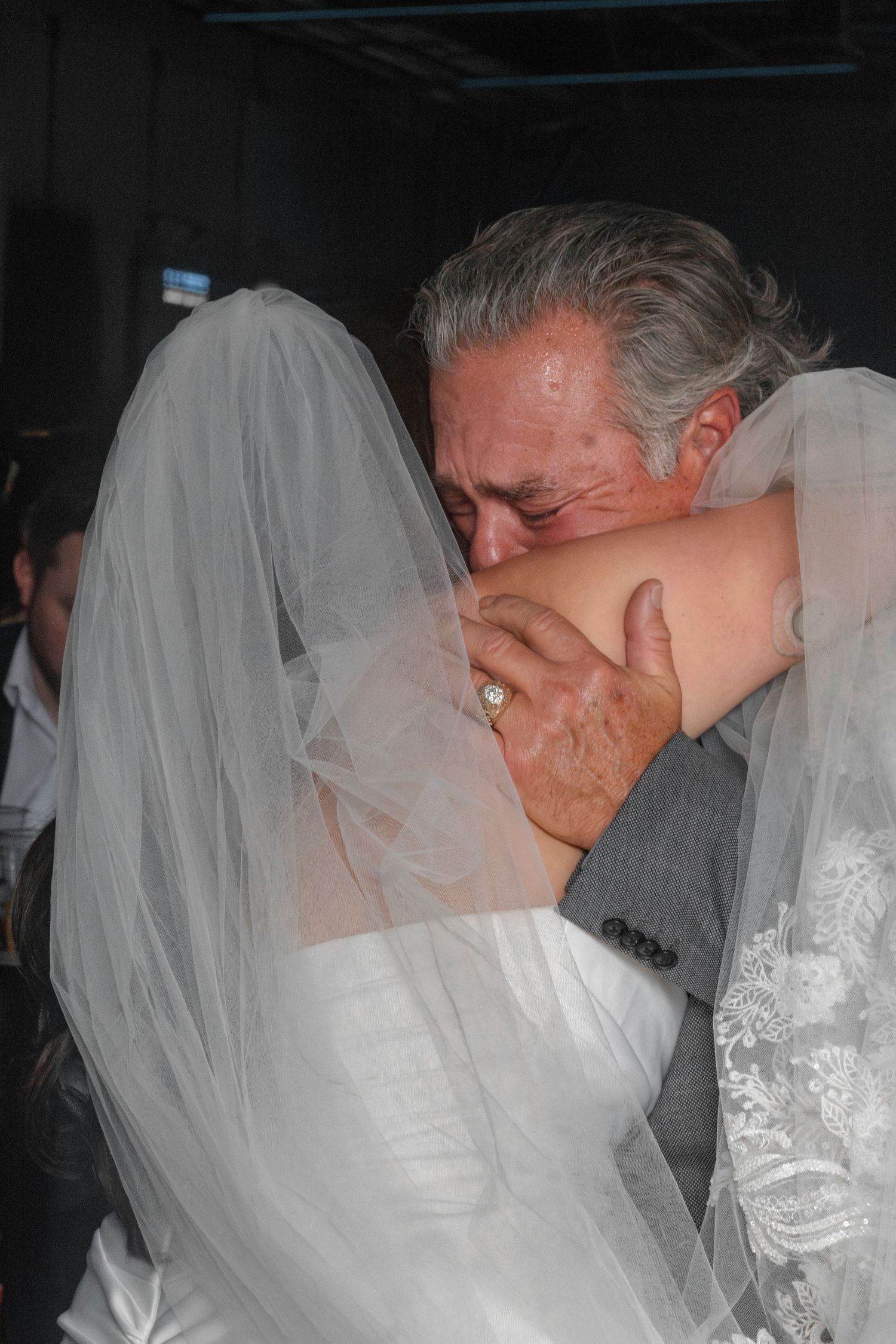 Emotional father-daughter moment captured during wedding ceremony.