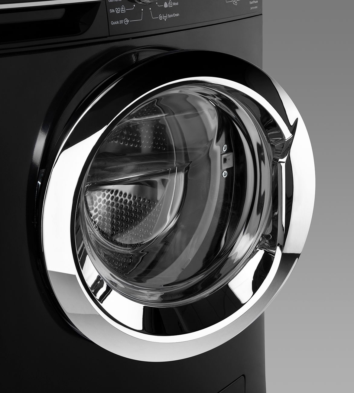 Modern black washing machine door with chrome trim and circular glass window.