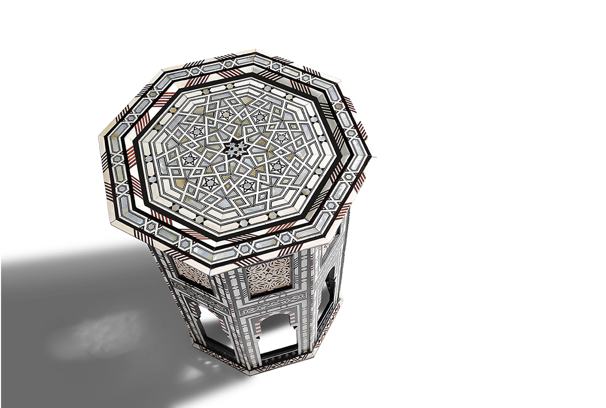 Octagonal crystal glass with intricate geometric pattern casting dramatic shadow.