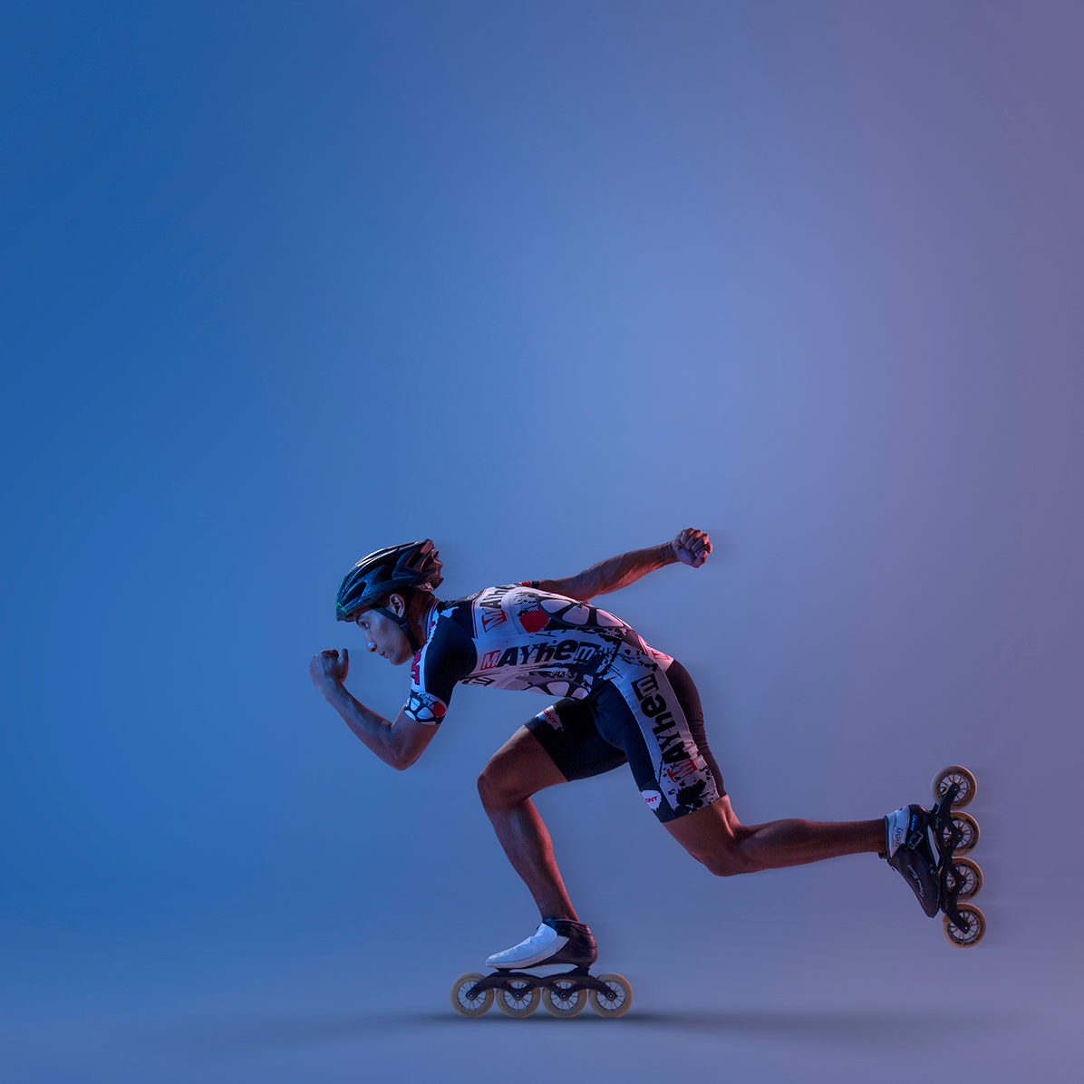 Inline skater in dynamic racing position wearing protective gear.