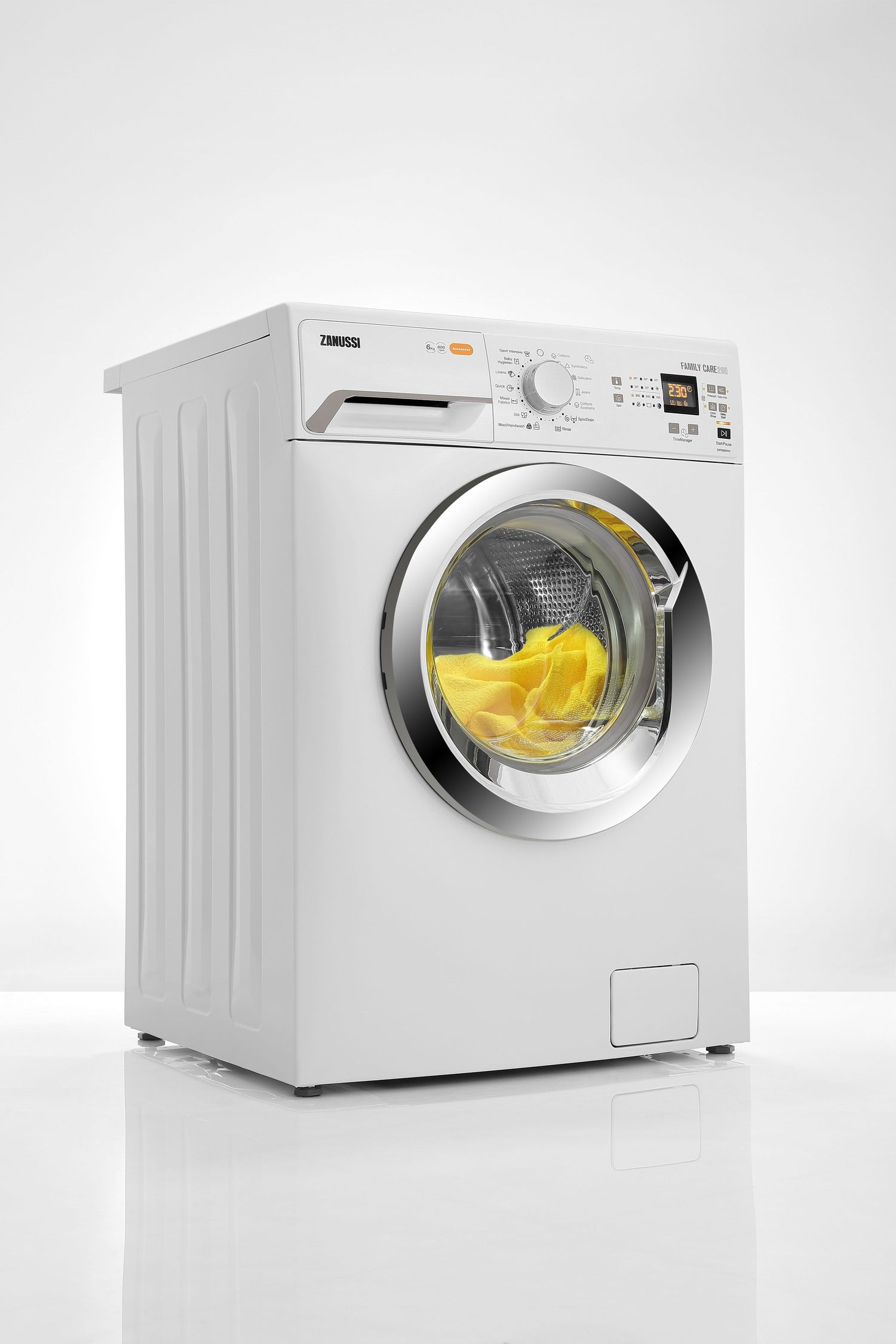 White front-loading washing machine with yellow garment visible through glass door.