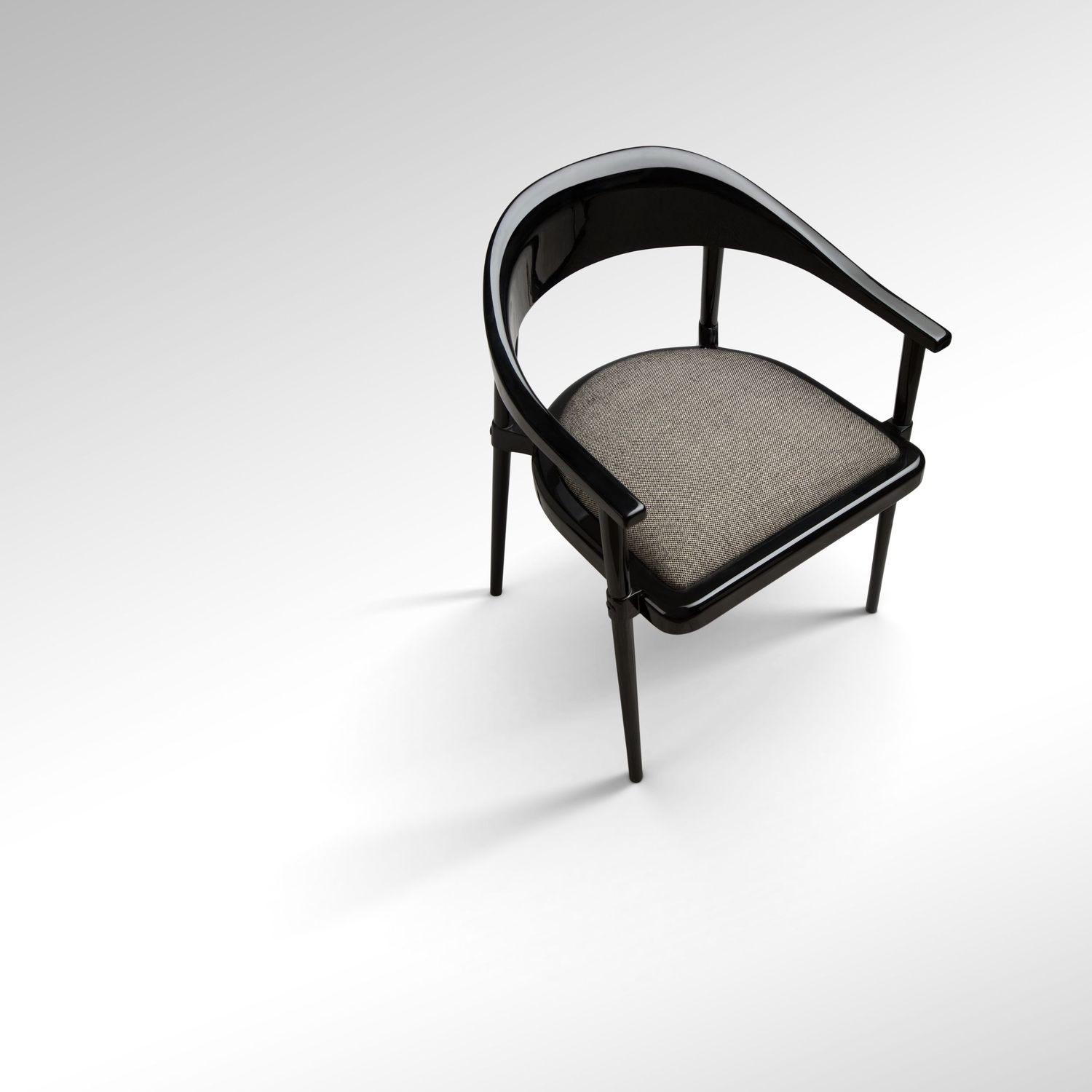Sleek black armchair with curved backrest and gray cushioned seat on white background.