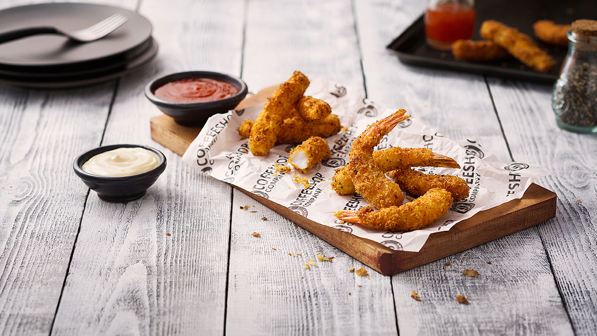 Crispy chicken wings served with dipping sauces on white paper liner.