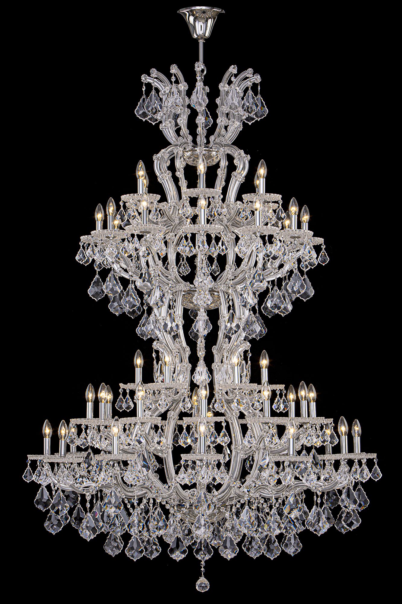Ornate crystal chandelier with multiple tiers and intricate glass details against black background.
