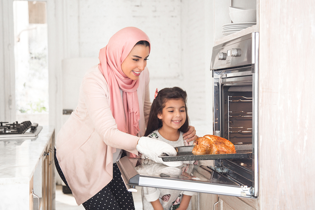 Two people baking fresh bread together in modern kitchen setting.