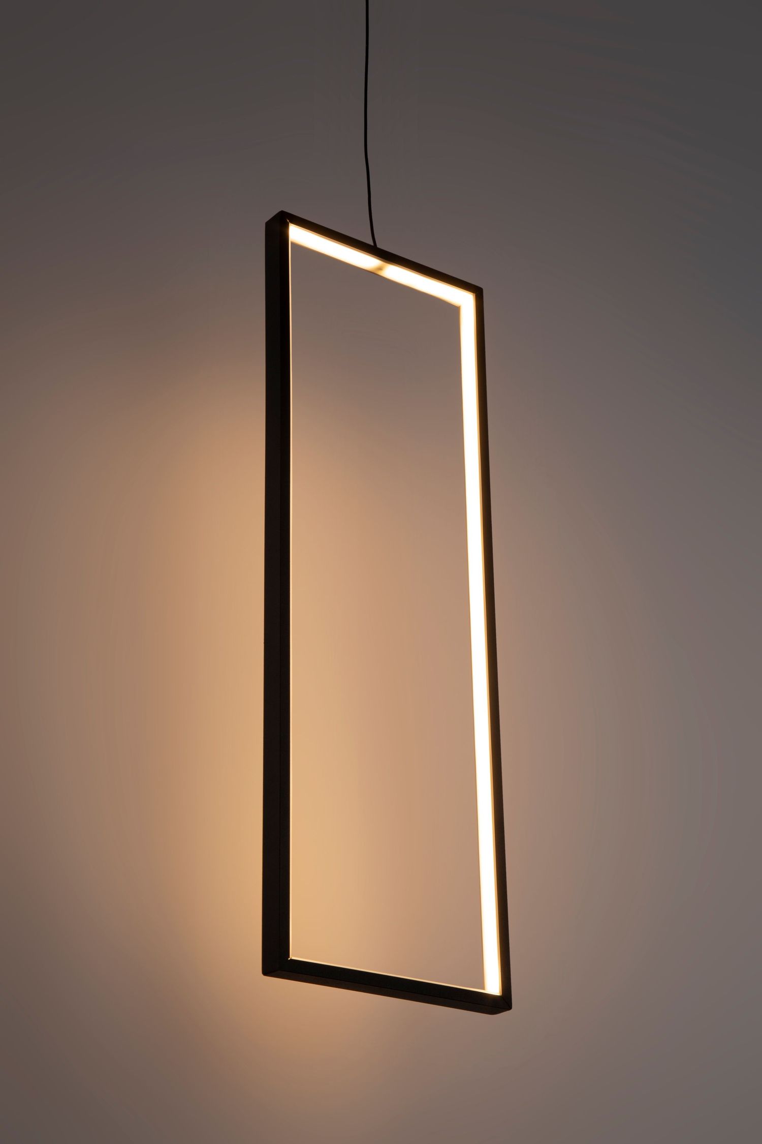 Minimalist rectangular LED pendant light with illuminated frame against dark background.