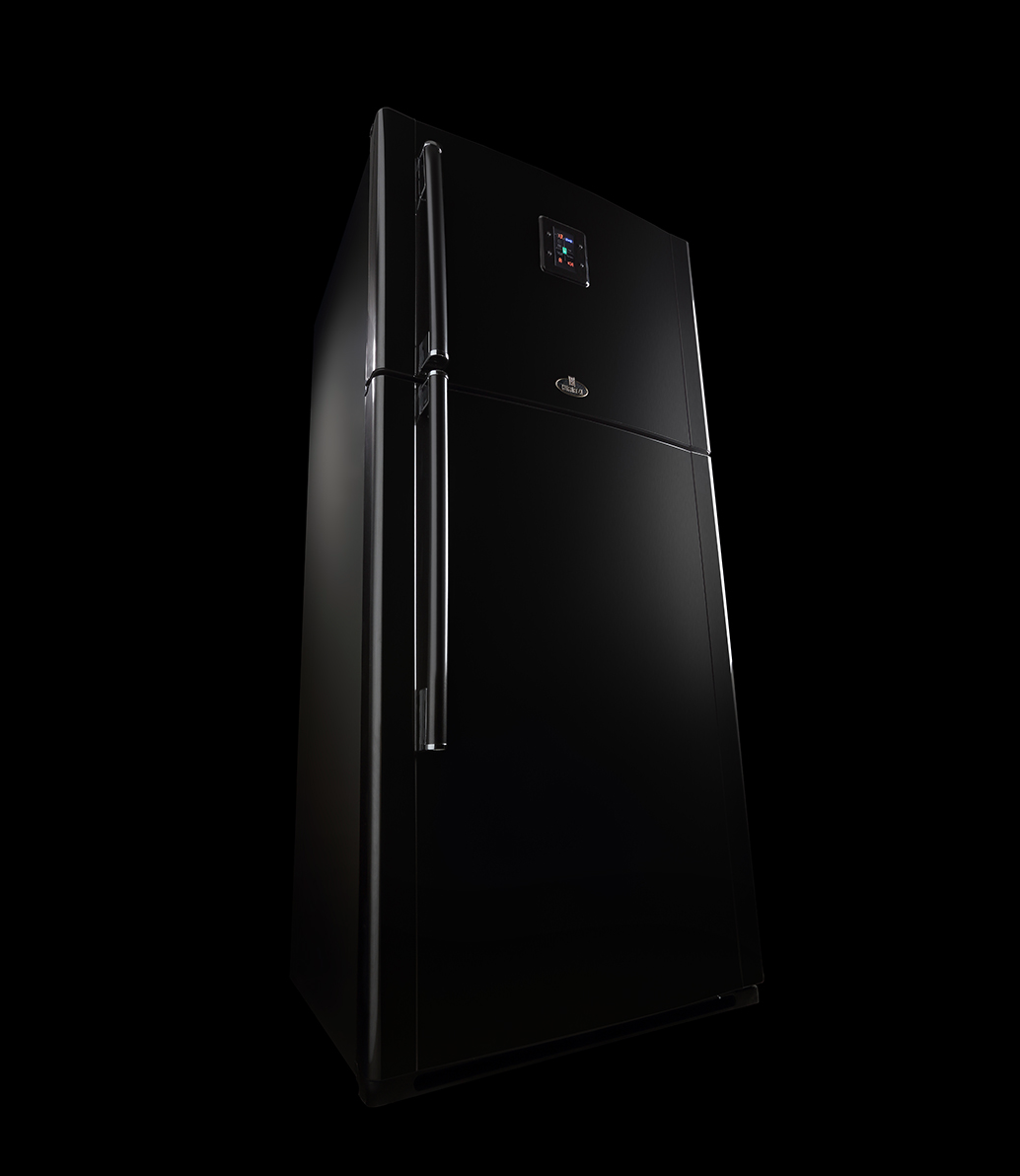 Sleek black refrigerator photographed dramatically against dark background.