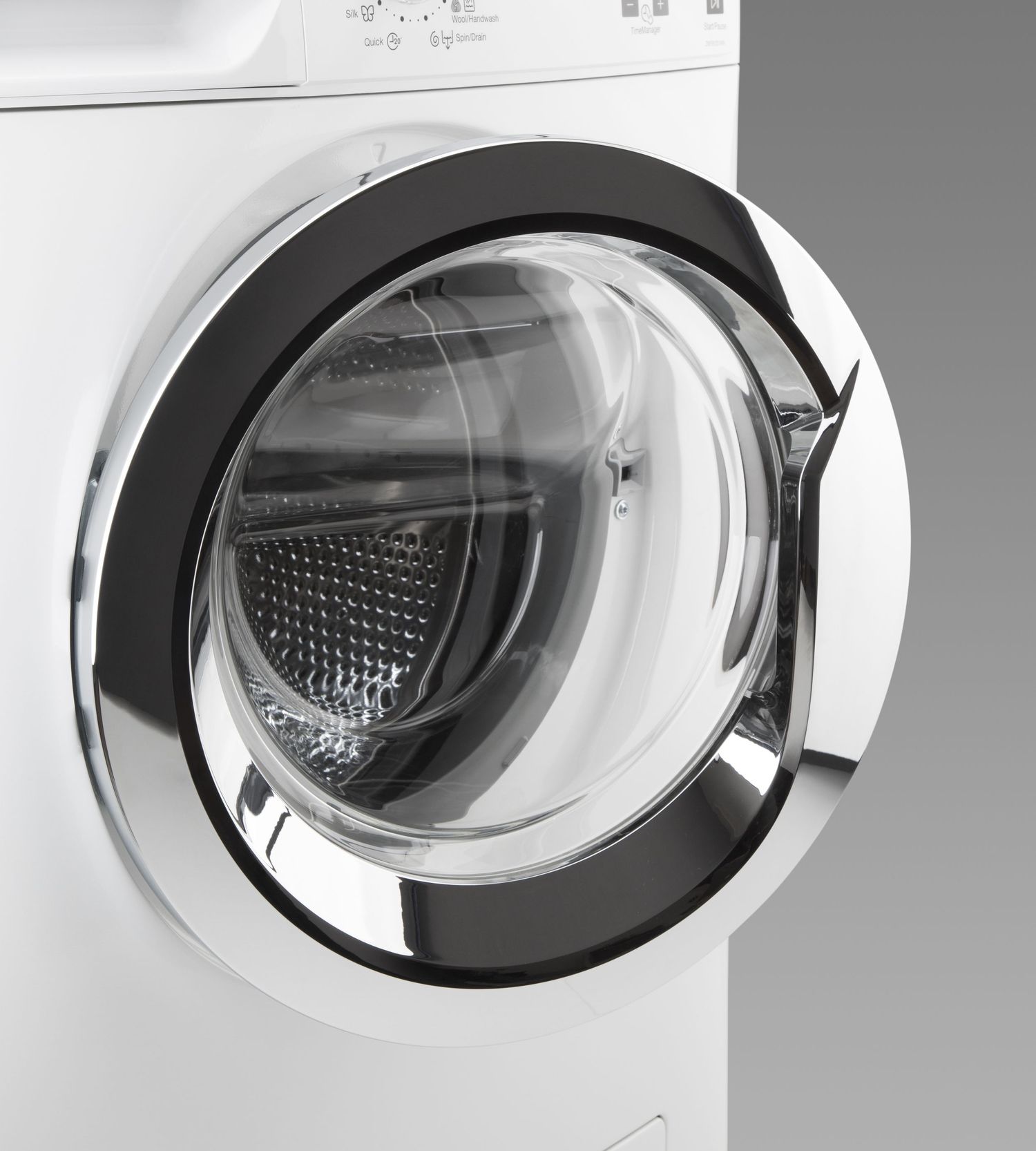 Front view of white washing machine door with transparent round window.