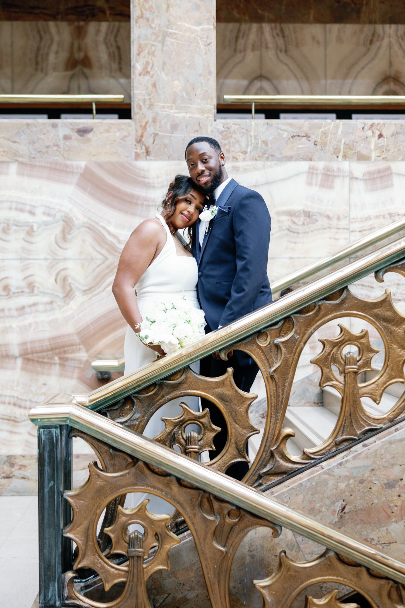 Shelana and Peter’s couple portrait on the stairs with light at their London wedding, captured by Oisin Studios