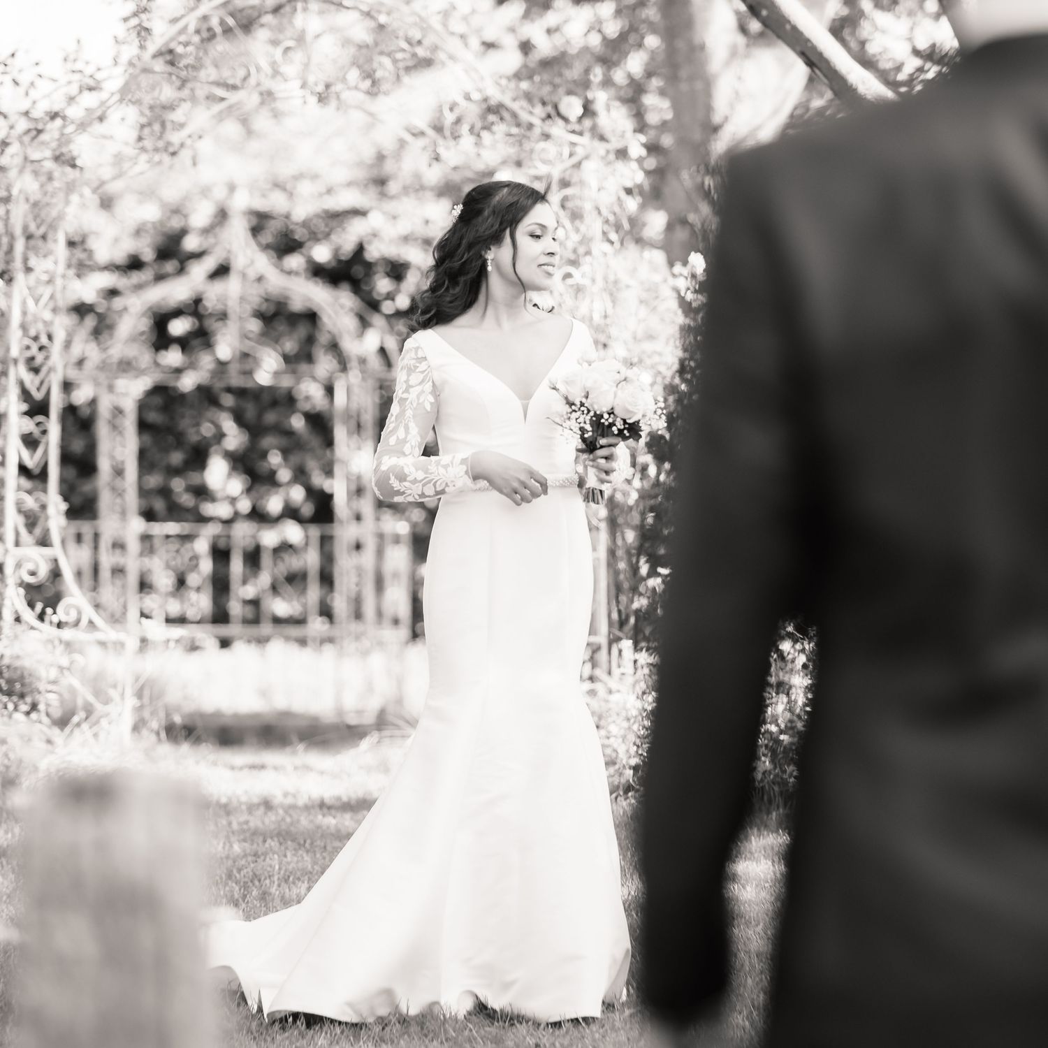 A series of ethereal black and white wedding photos showing romantic moments in an outdoor garden setting.