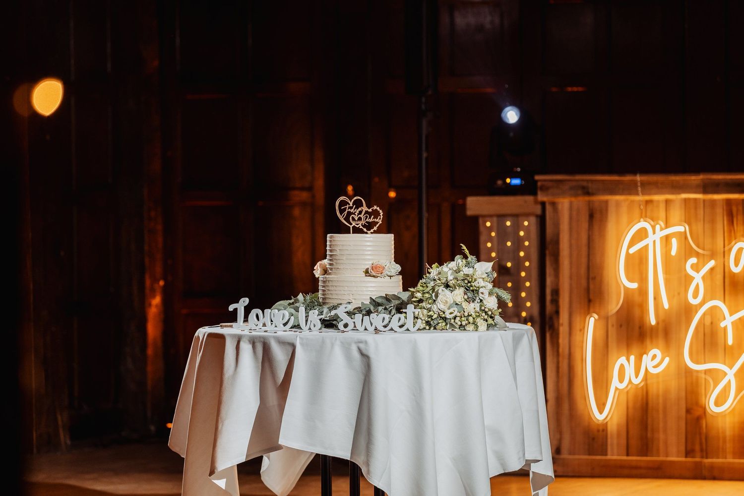 Jade and Richard cutting their wedding cake at the Great Fosters venue, captured by Oisin Studios