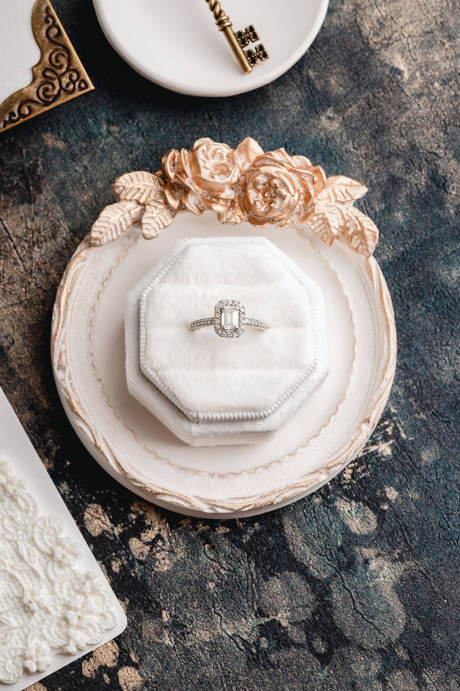 Fine art wedding ring flatlay with soft tones and elegant styling by Oisin Studios.