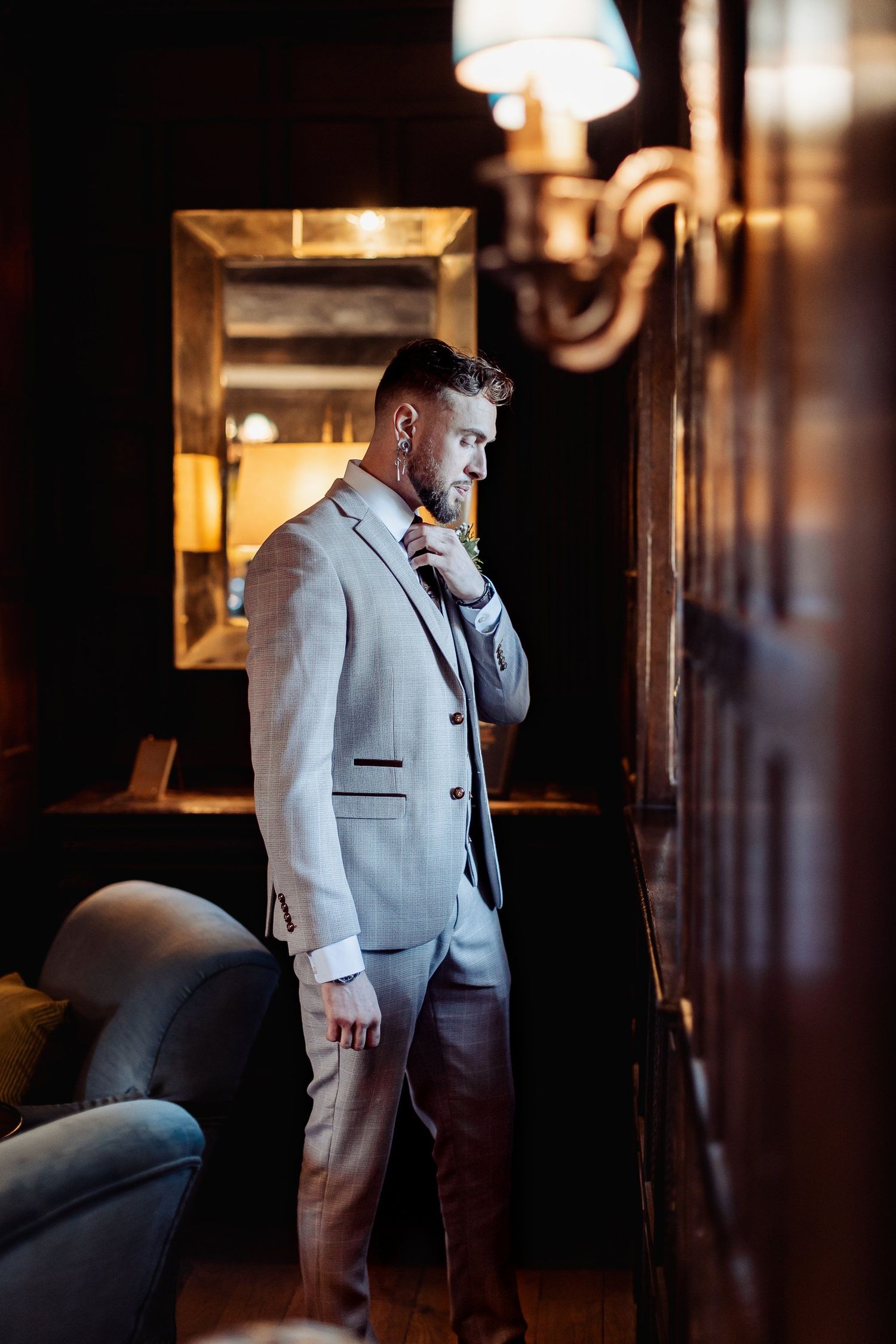 Groom fixing his tie before the ceremony — storytelling wedding photography by Oisin Studios