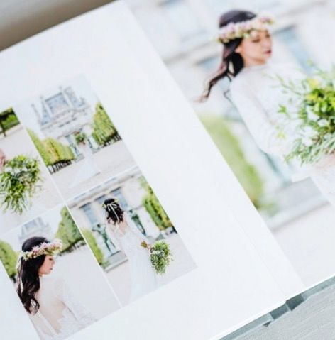 Open wedding photo album displaying elegant bridal portraits with floral crowns and bouquets.