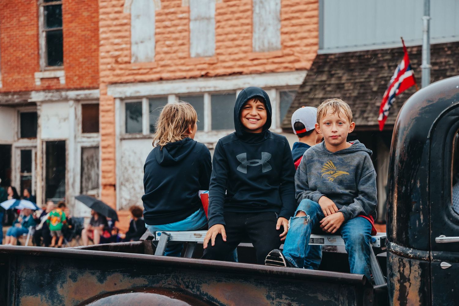 Youth riding in a vintage truck during a small town parade.