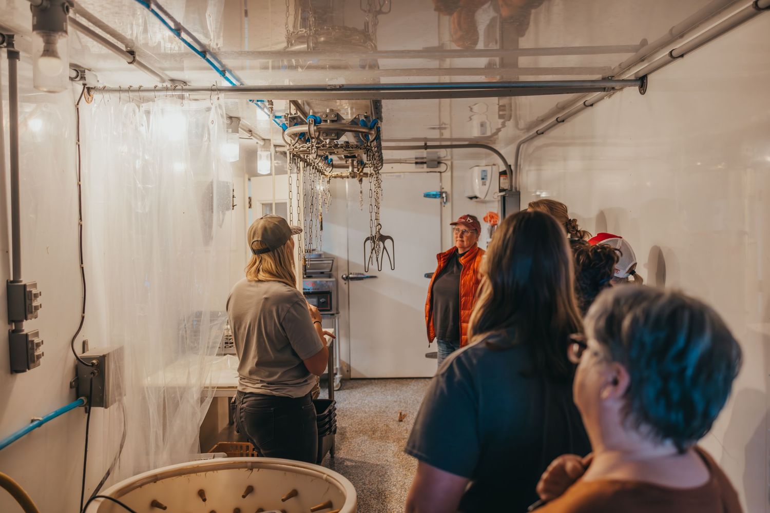 Tour group observing equipment in an industrial processing facility.
