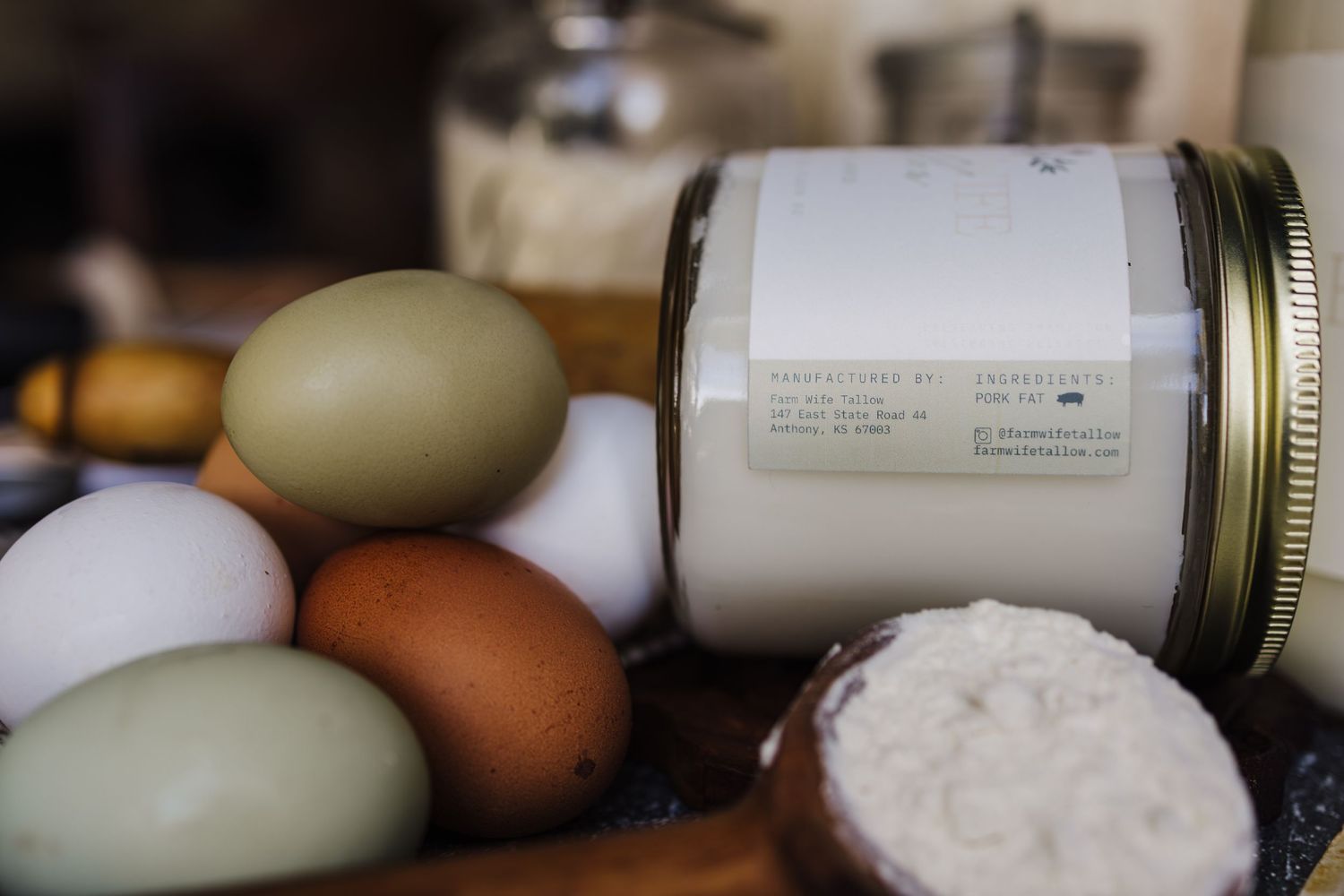 Fresh farm eggs and mason jars filled with dairy products arranged on a rustic wooden surface.