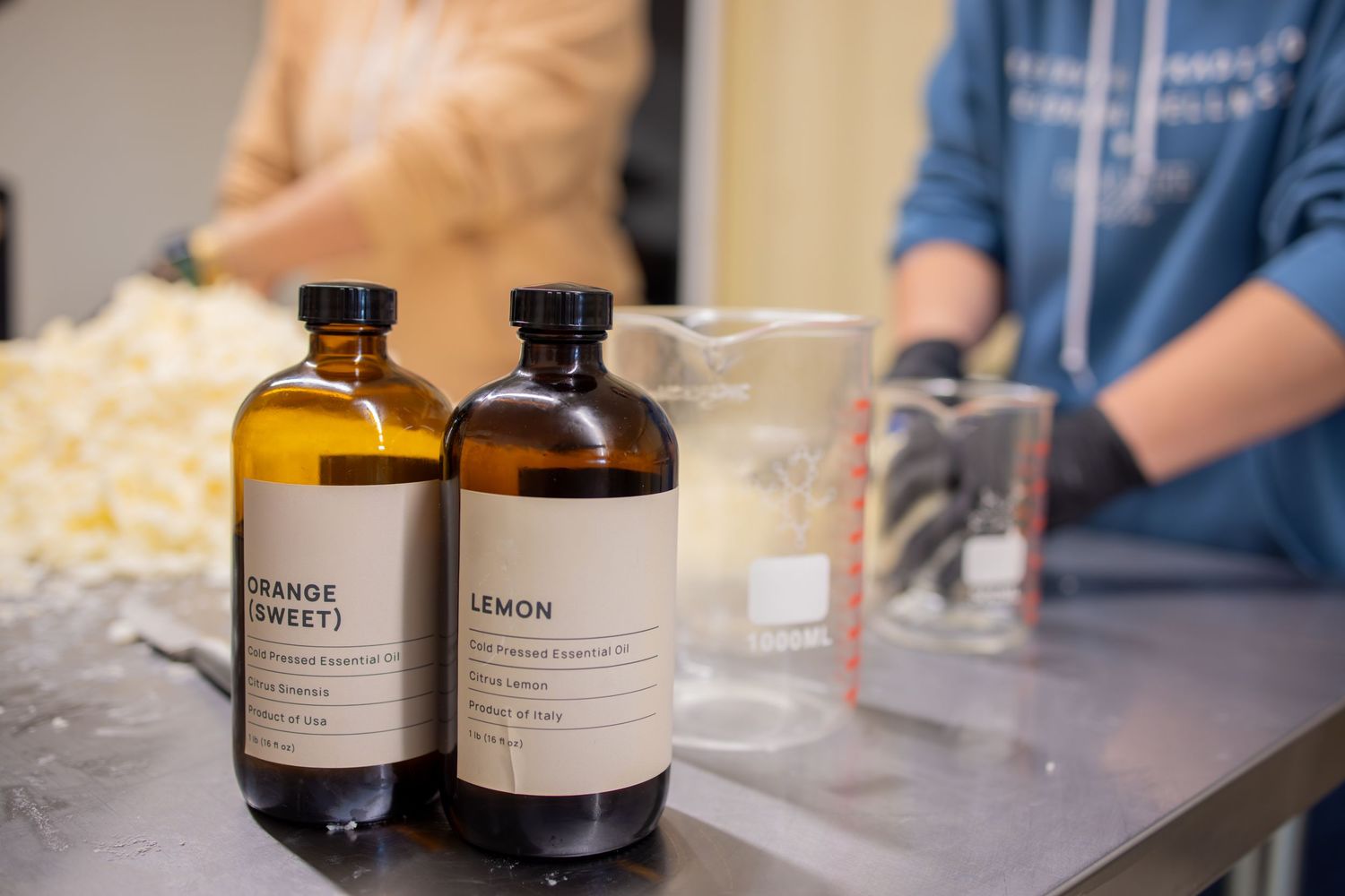 Glass bottles of ingredients alongside measuring equipment on a counter.