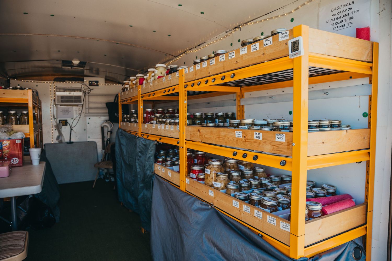 Industrial shelving units store blue water cooler jugs in a warehouse storage facility.