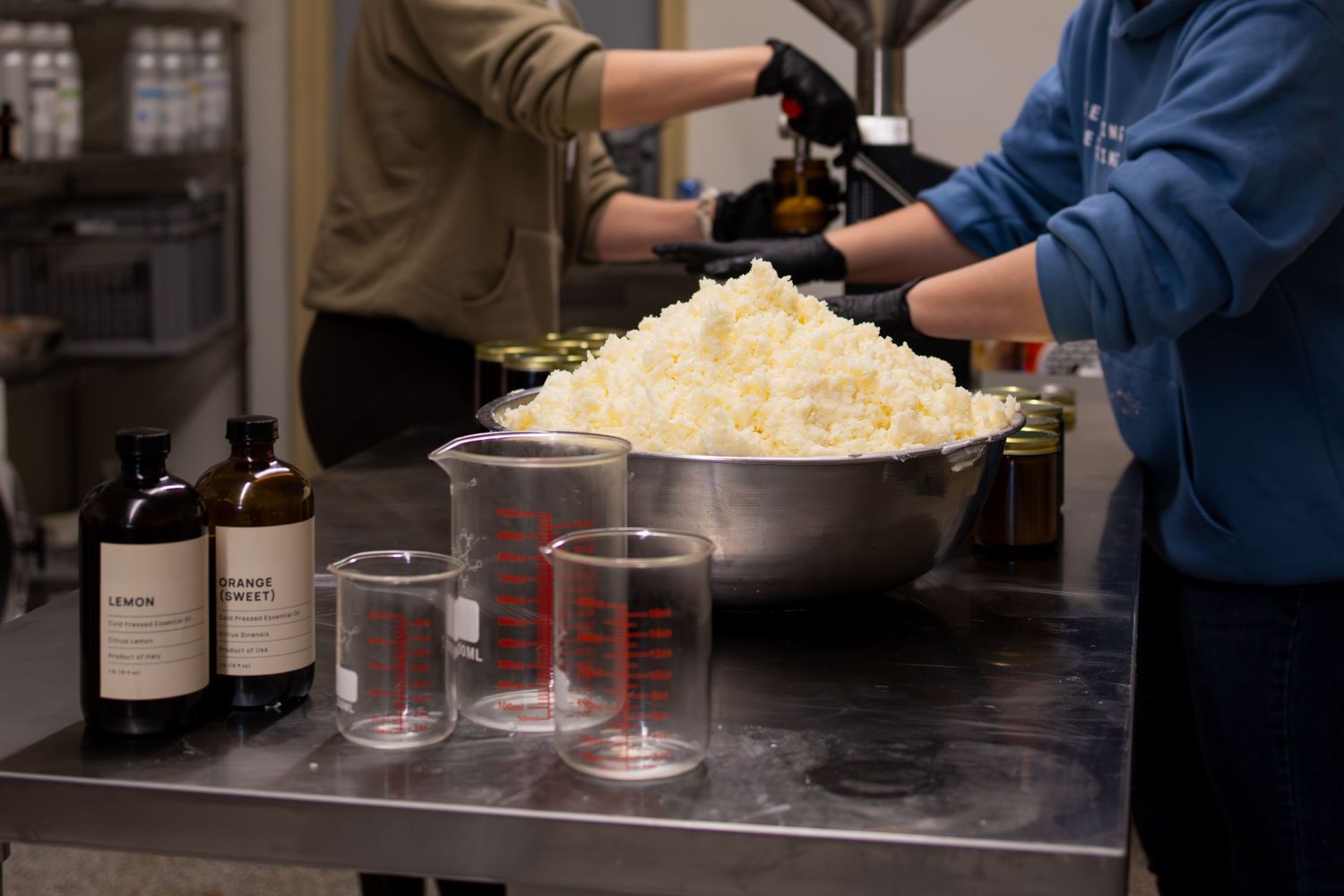 Industrial kitchen setup with measuring equipment and large bowl of prepared ingredients.