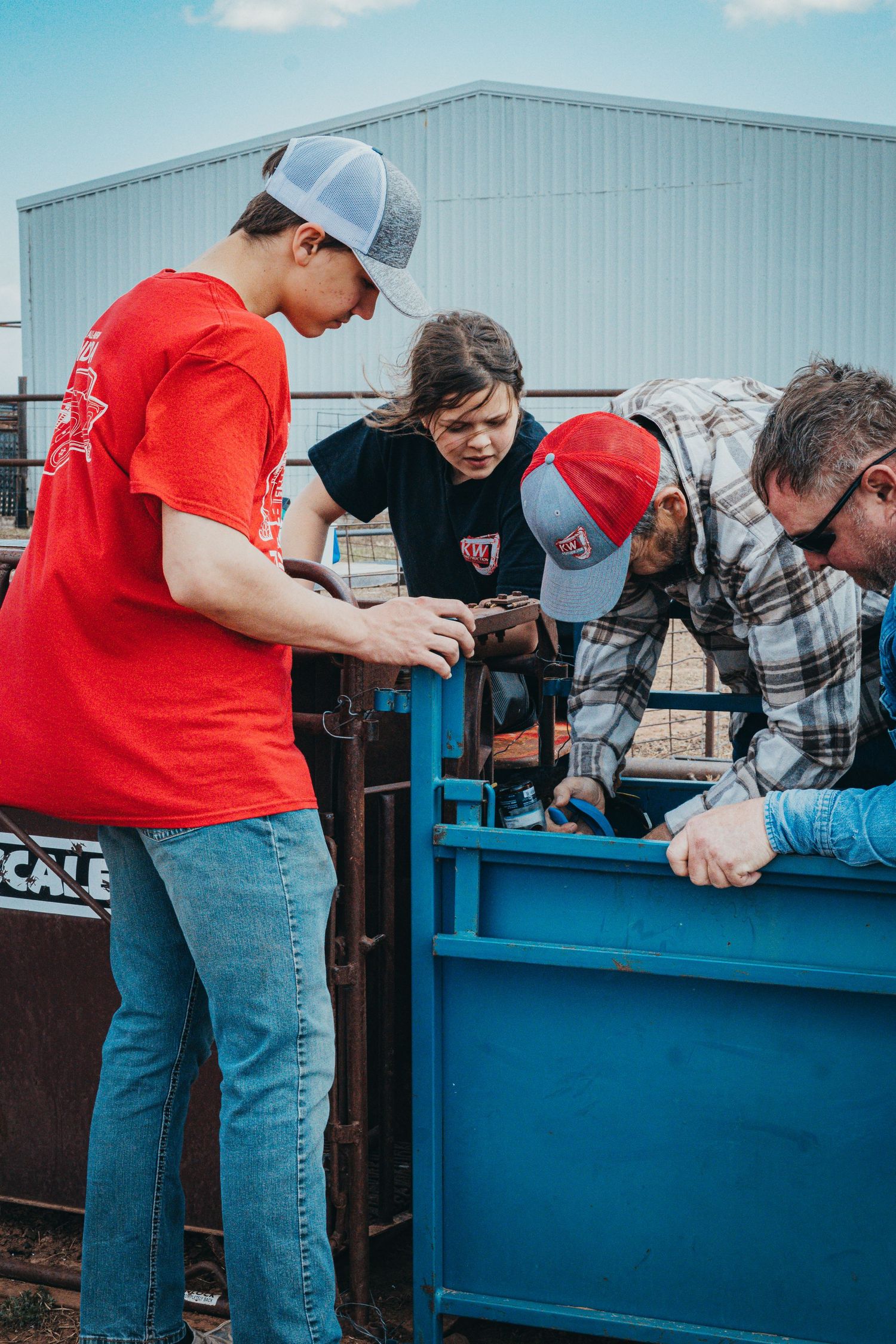 Group examining equipment at an outdoor agricultural event.