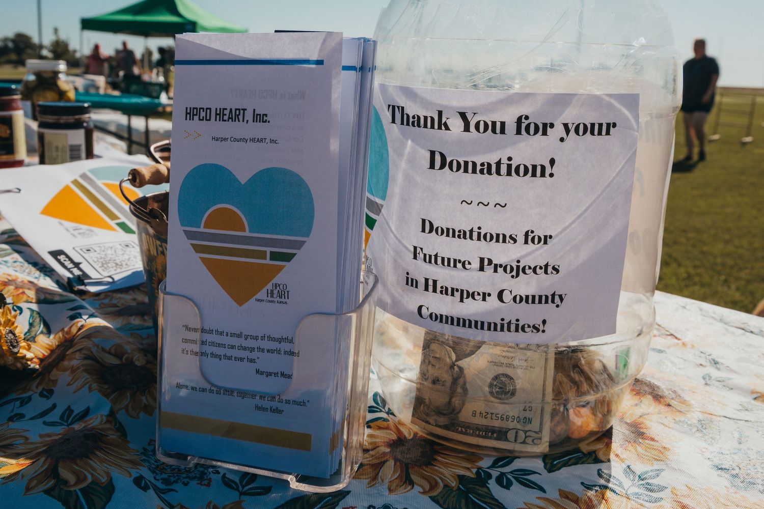 Donation collection boxes with thank you signs arranged at a community fundraising event.