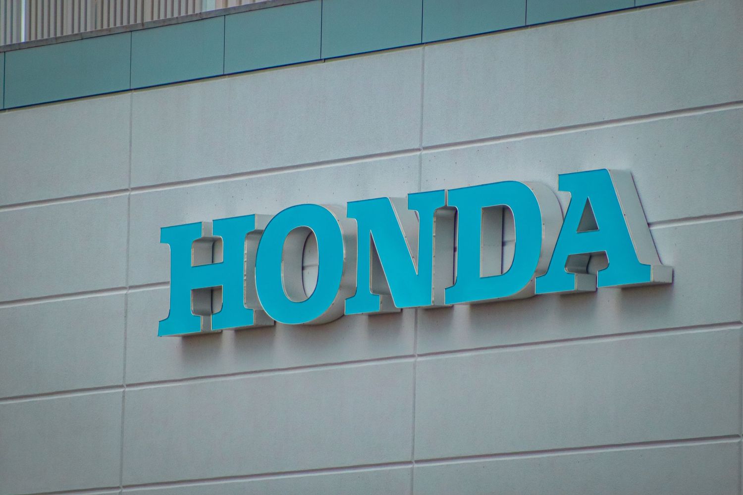 Large blue Honda signage mounted on a modern building exterior.