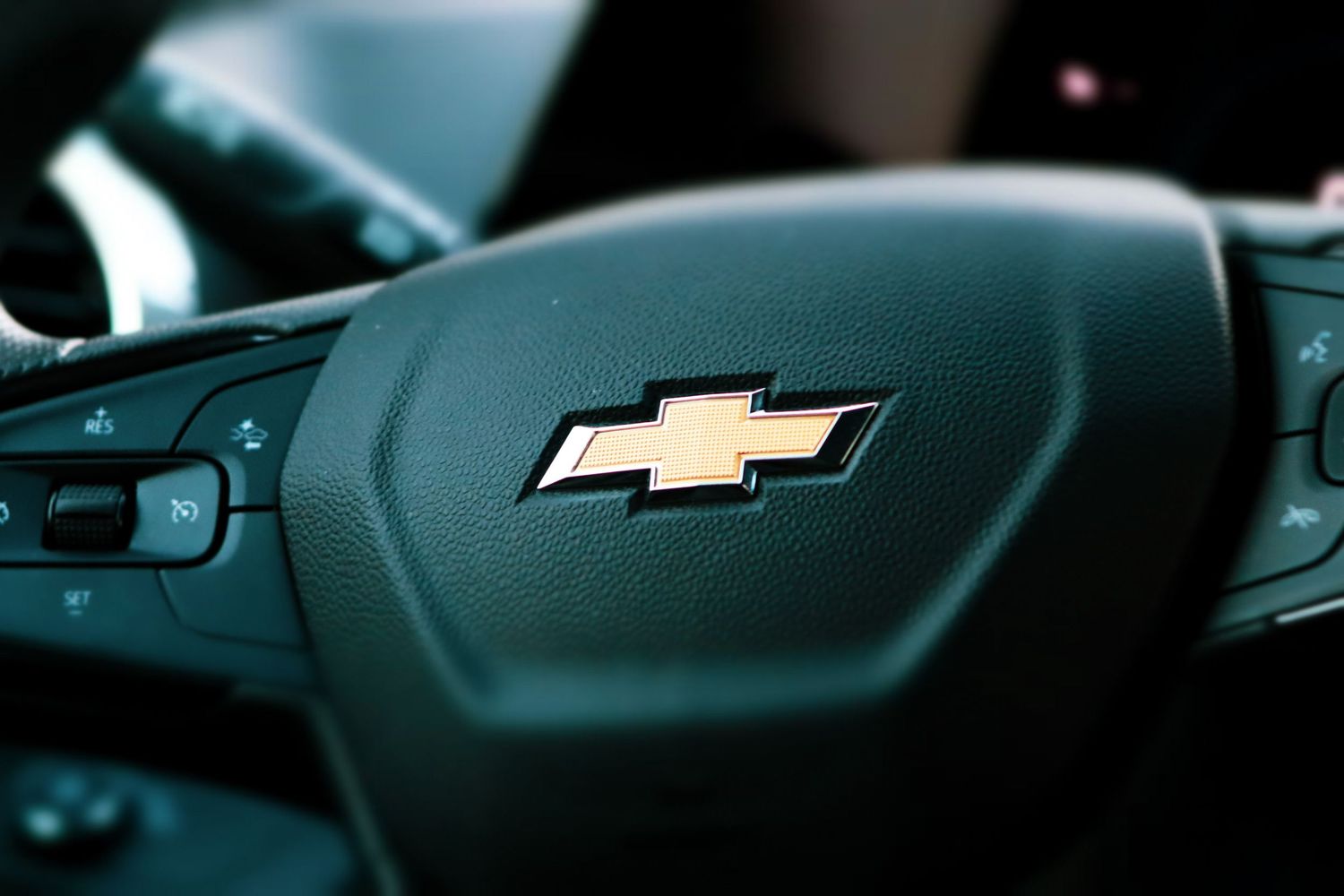 Close-up of a Chevrolet steering wheel with the iconic bowtie logo.