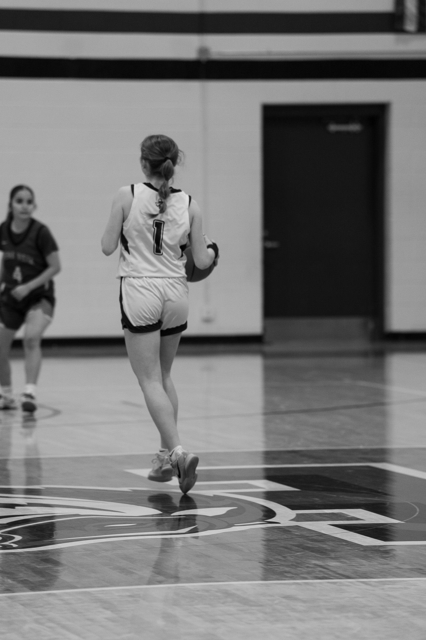 Close-up view of basketball court lines and players' feet during game action.