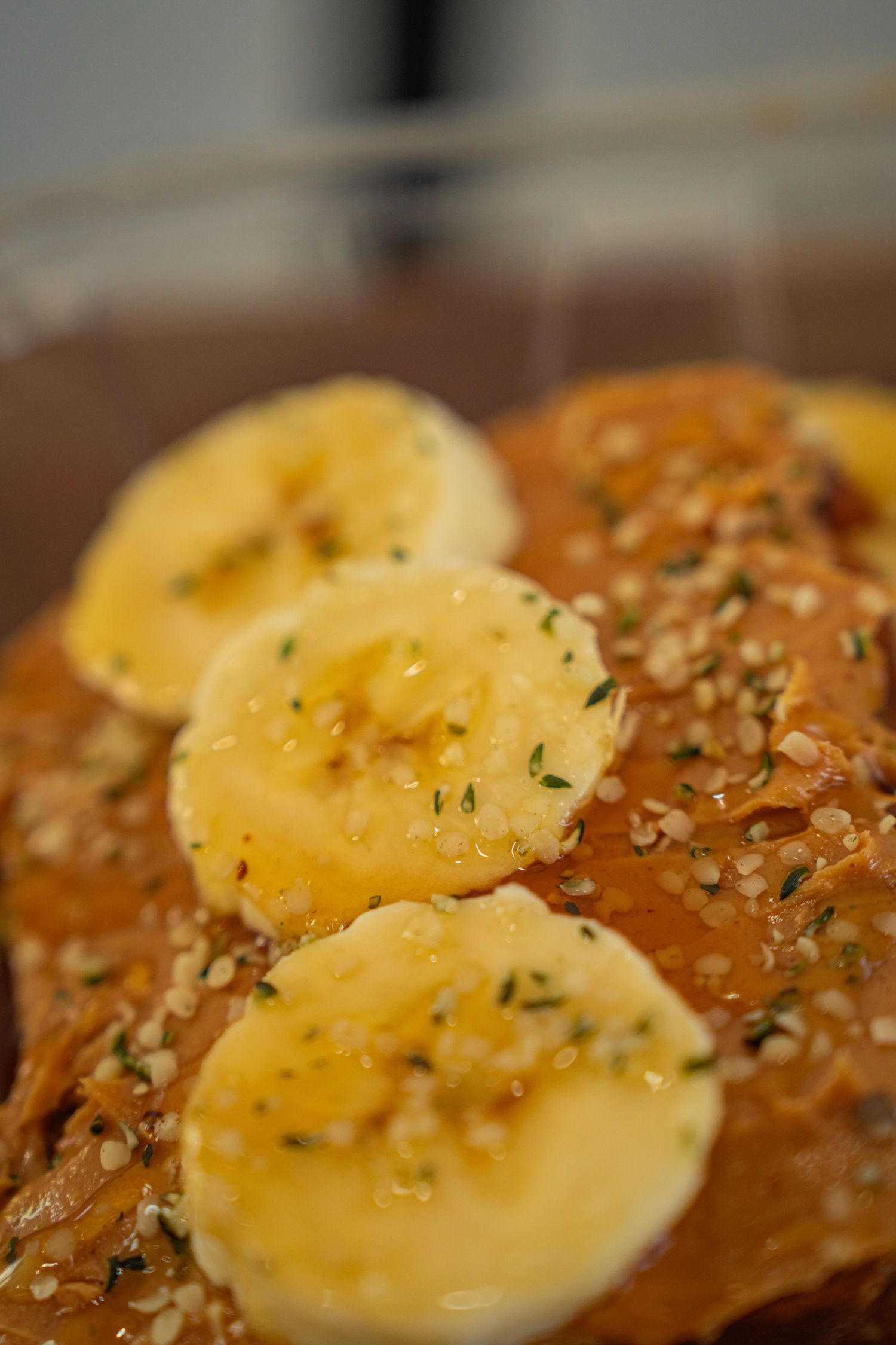 Sliced hard boiled eggs topped with seasoning and herbs on toasted bread create an elegant open-faced sandwich.