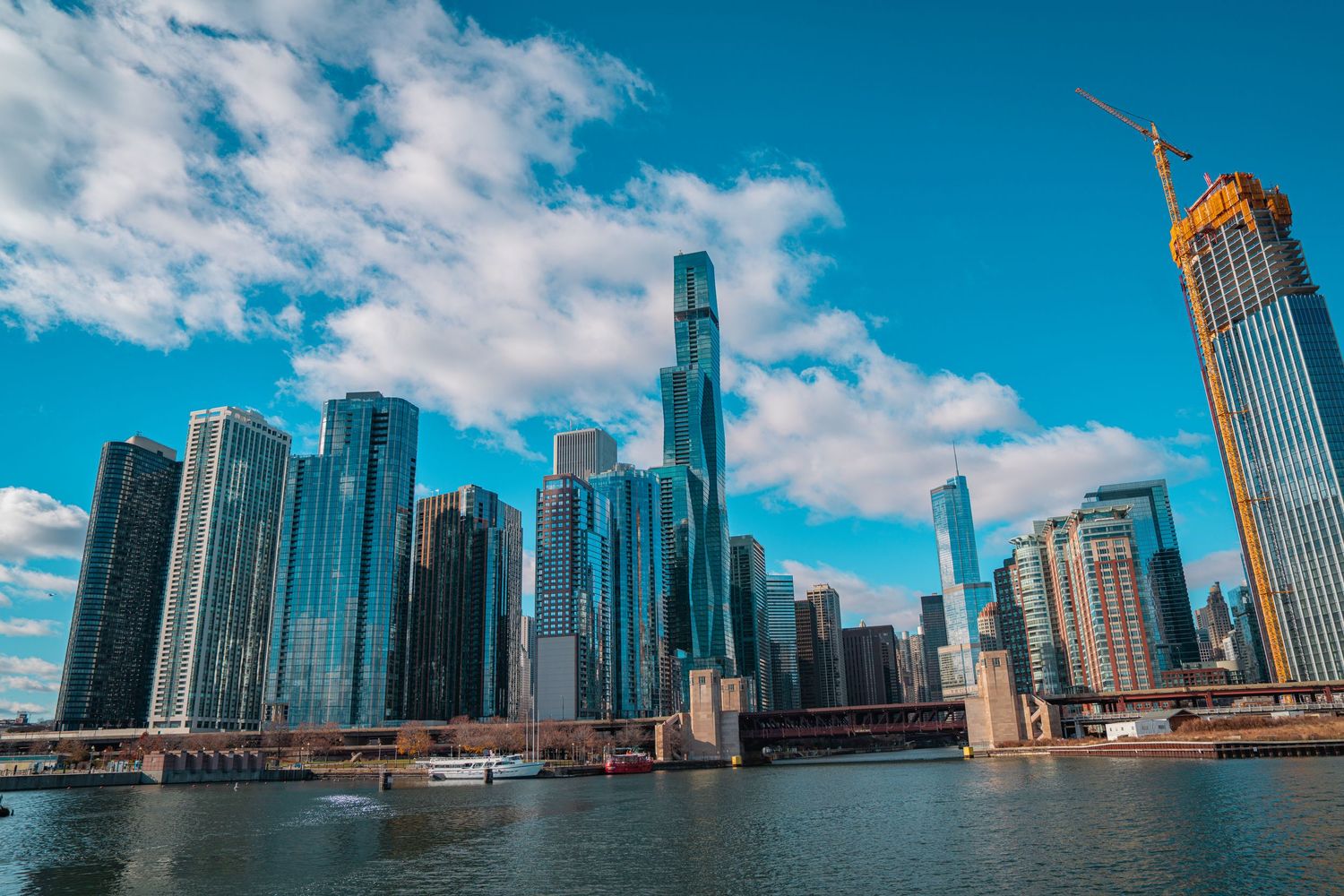 Panoramic cityscape of Chicago's iconic skyline along Lake Michigan with modern skyscrapers under blue skies.