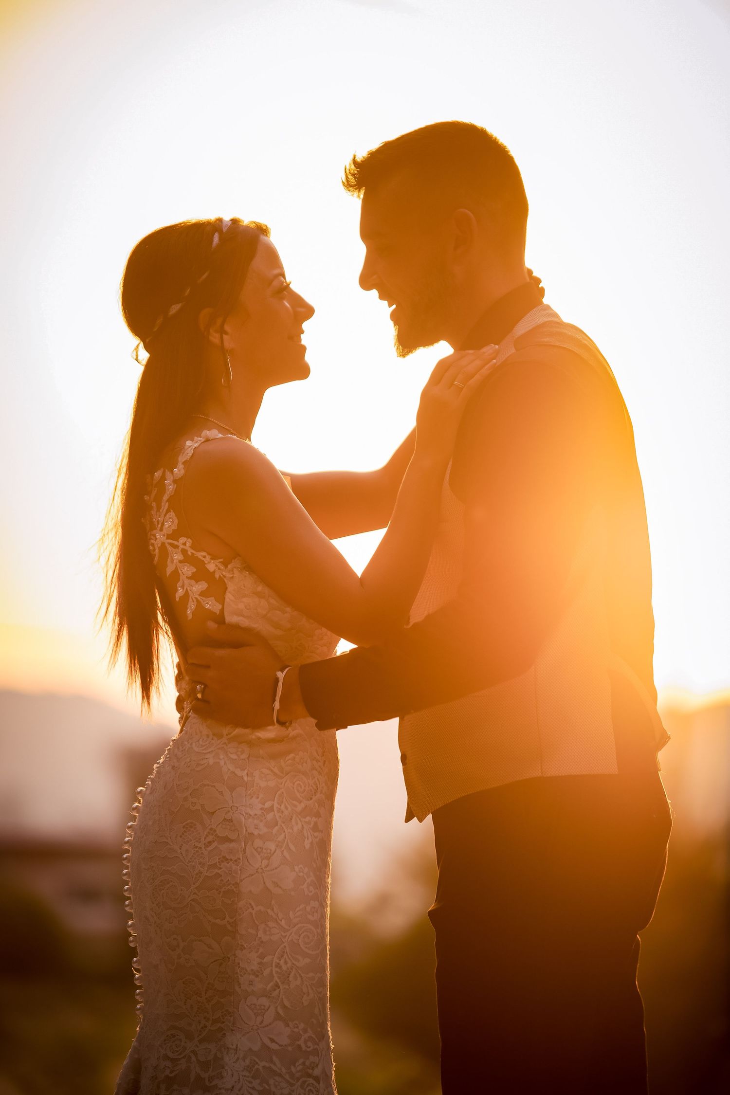 Silhouette of a couple embracing during golden hour sunset.