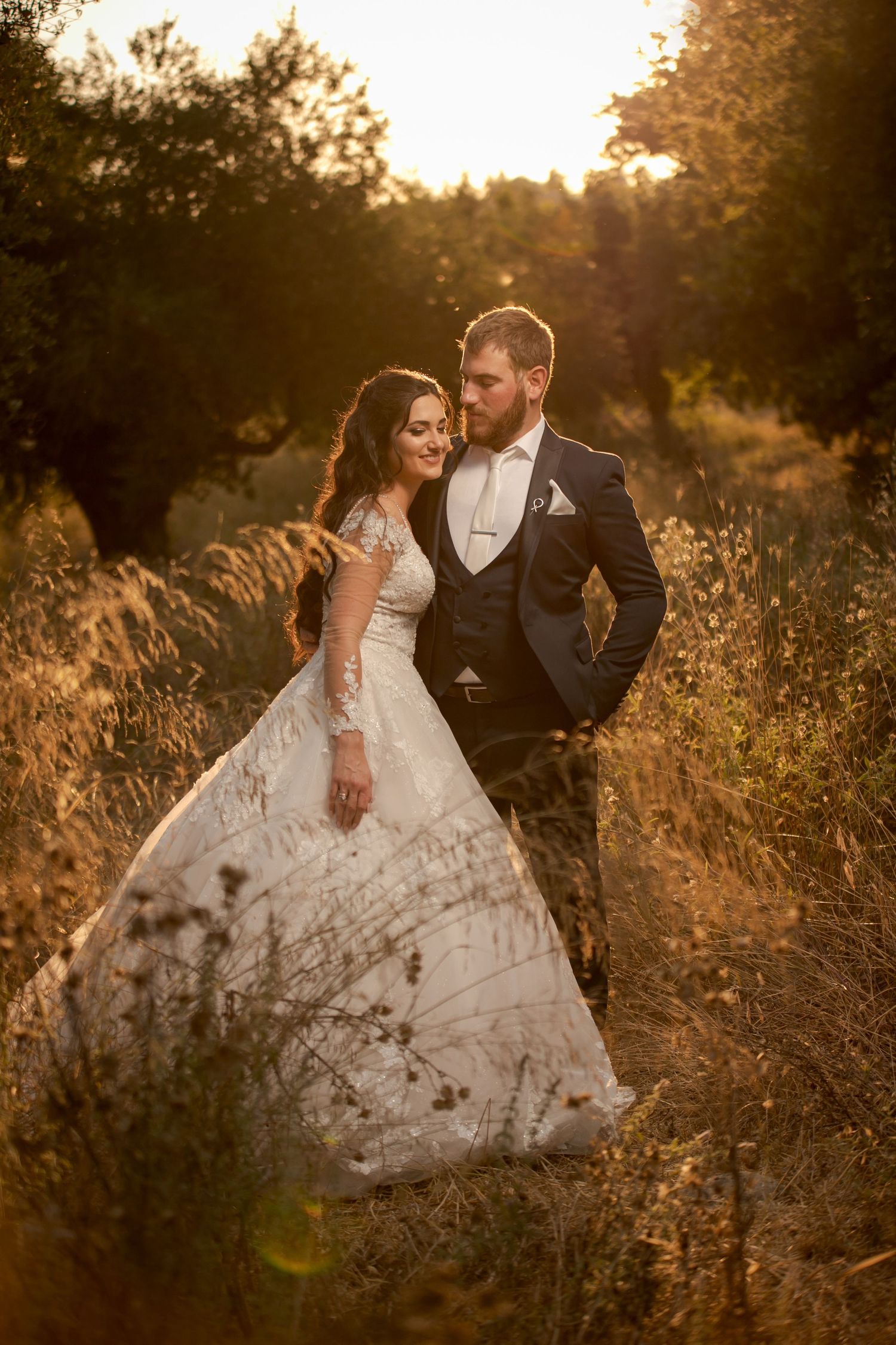 Romantic golden hour portrait session in rustic field with wildflowers.