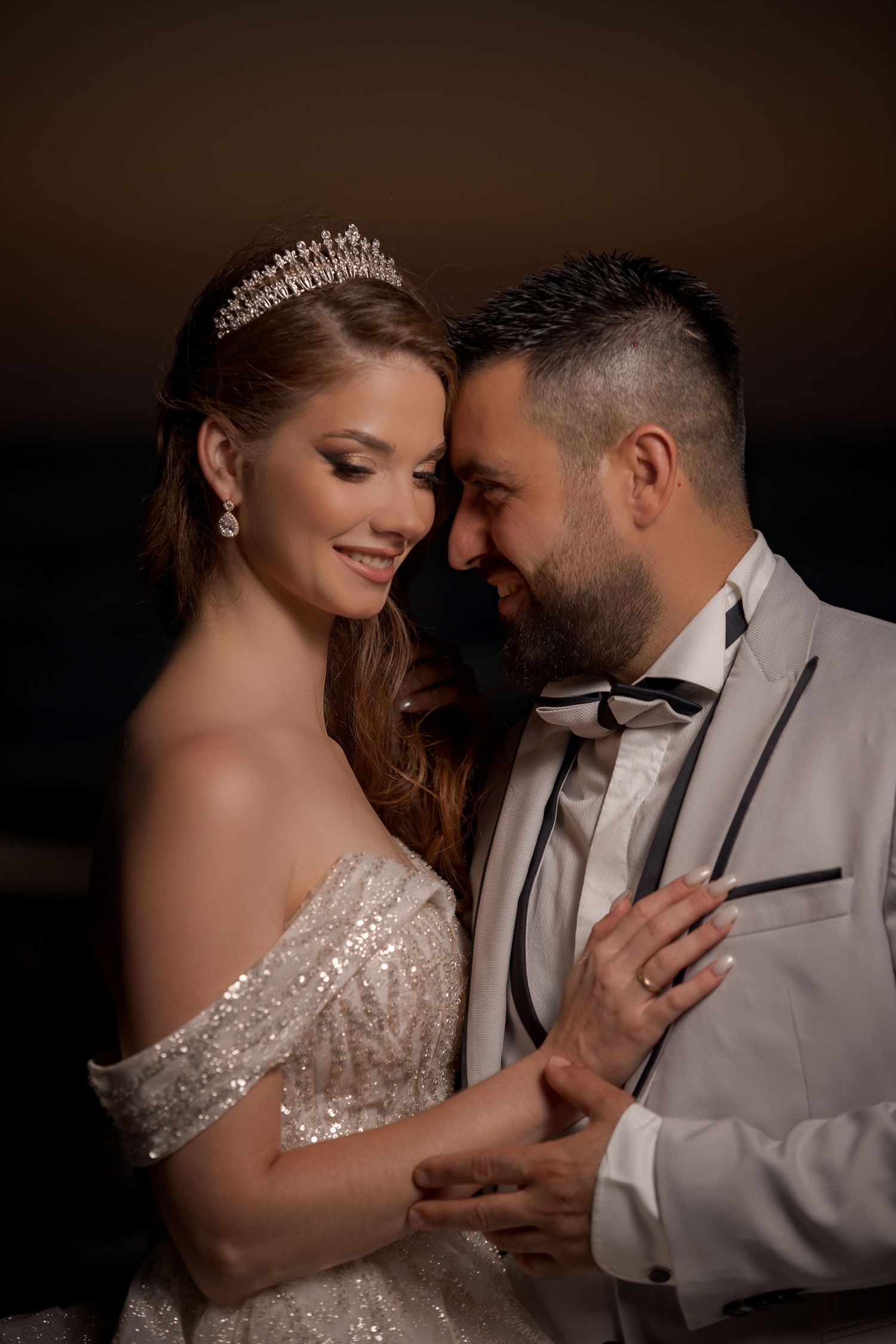 Glamorous indoor wedding portraits featuring sparkling details and formal attire.