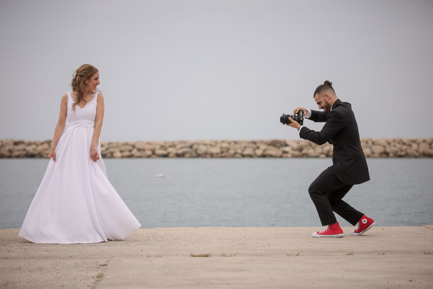 Wedding photography sequence on a beach showing playful interaction between couple.