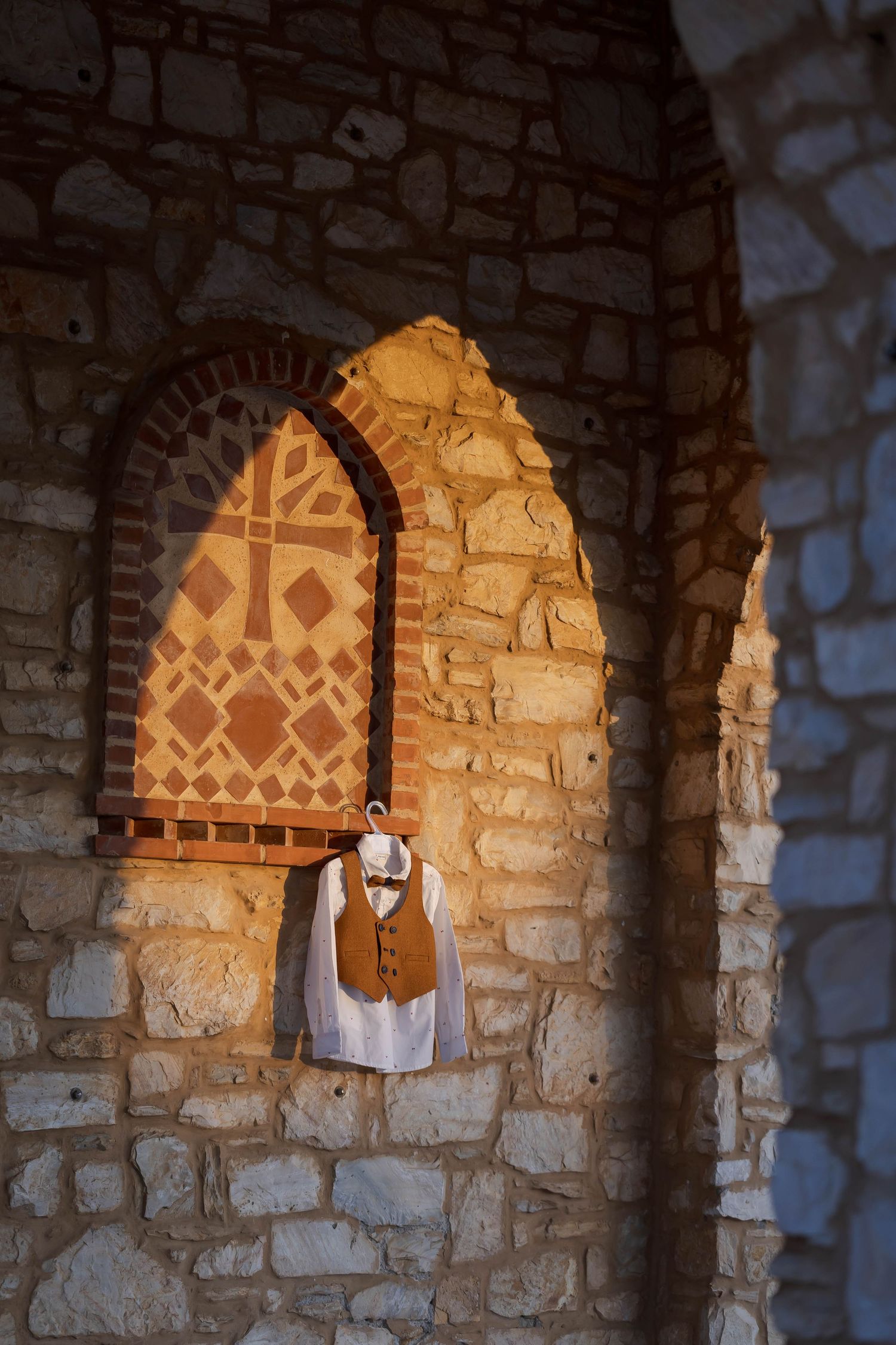 Stone archways in an ancient church with decorative painted patterns visible.