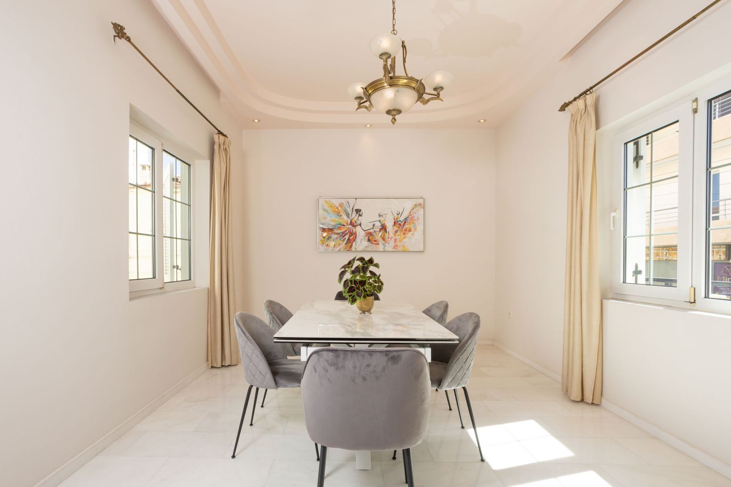 Bright and airy white interior room with modern furniture and natural sunlight.