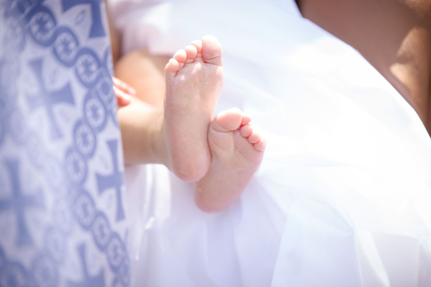 Close-up details of delicate white lace fabric in natural light.