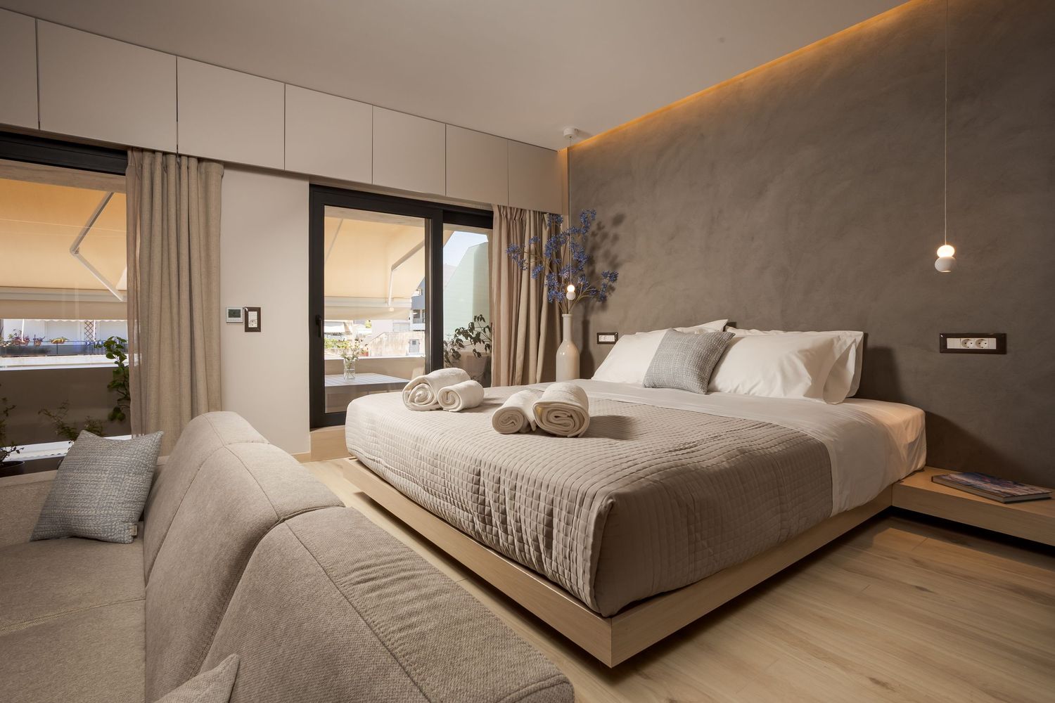 Modern bedroom interior with geometric panels and warm lighting showcases minimalist design and neutral color scheme.
